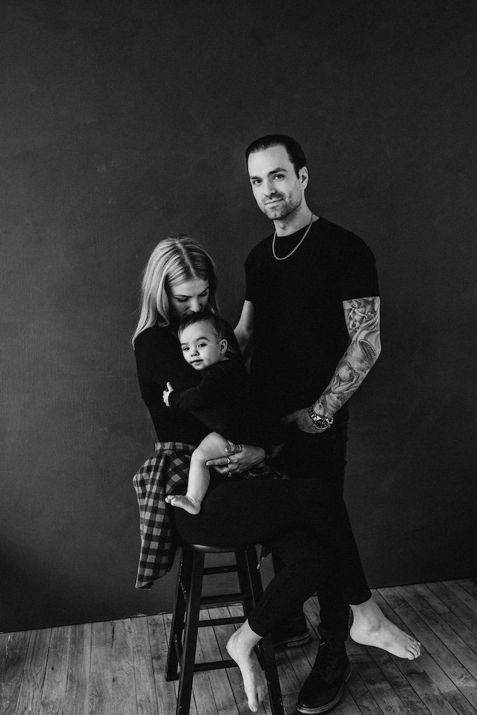 A family photograph in black and white in-front of black backdrop in Cleveland. 