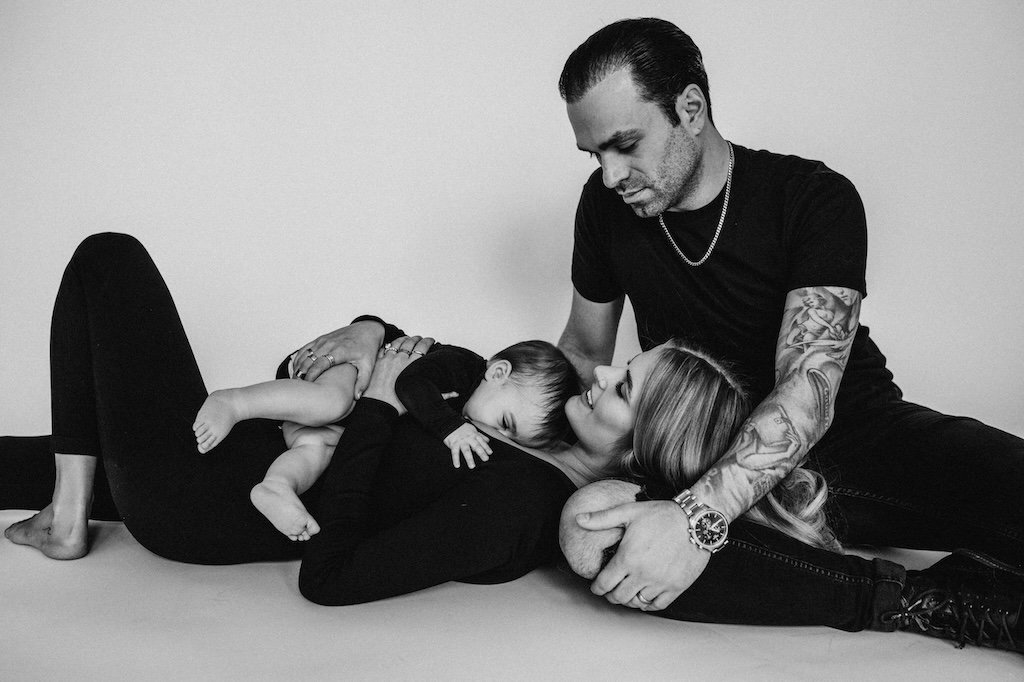 A family posing fro black and white portraits in Cleveland Ohio studio.