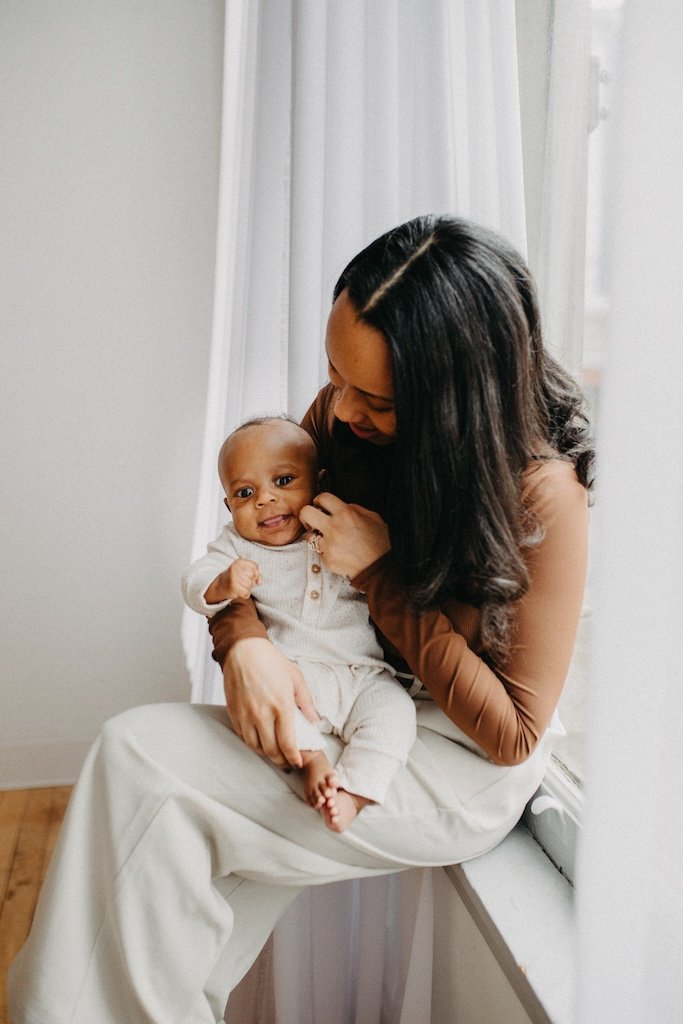 Mom and baby son dressed in neutral colors posing for portrait in photo studio in Cleveland, Ohio.