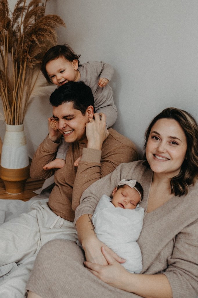 Family of four in the studio posing for pictures. 