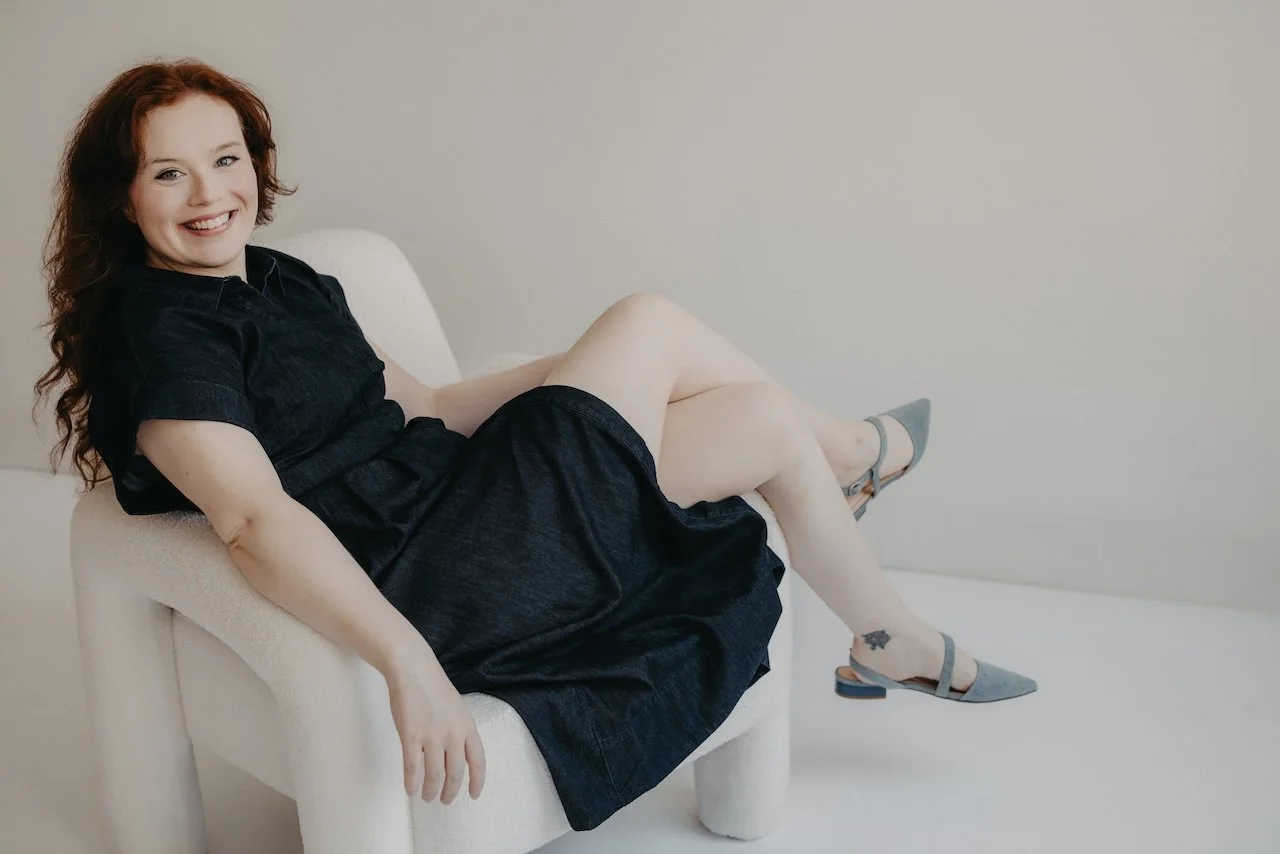 Portrait of woman sitting on chair in photography studio