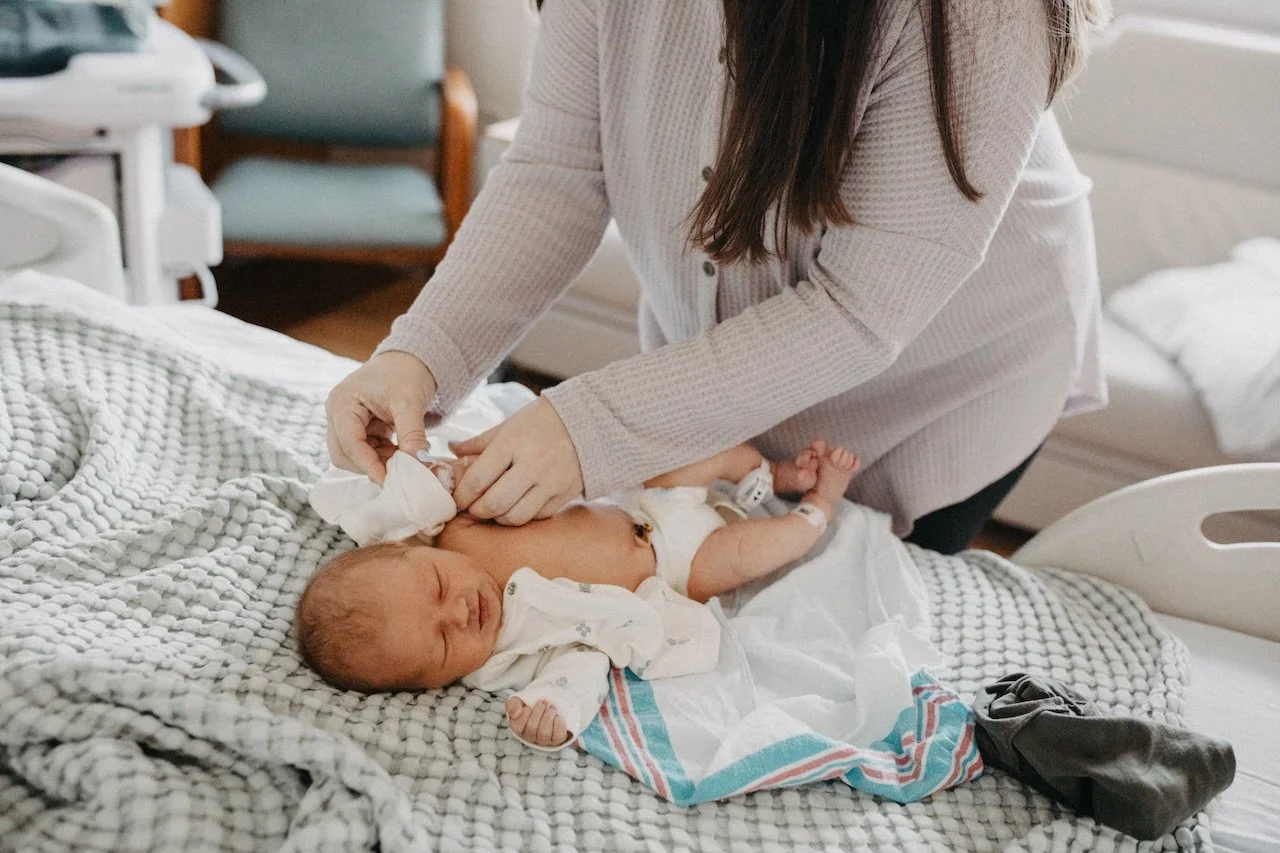 Cleveland Fresh 48 photographer capturing a mother holding her newborn baby in a hospital room