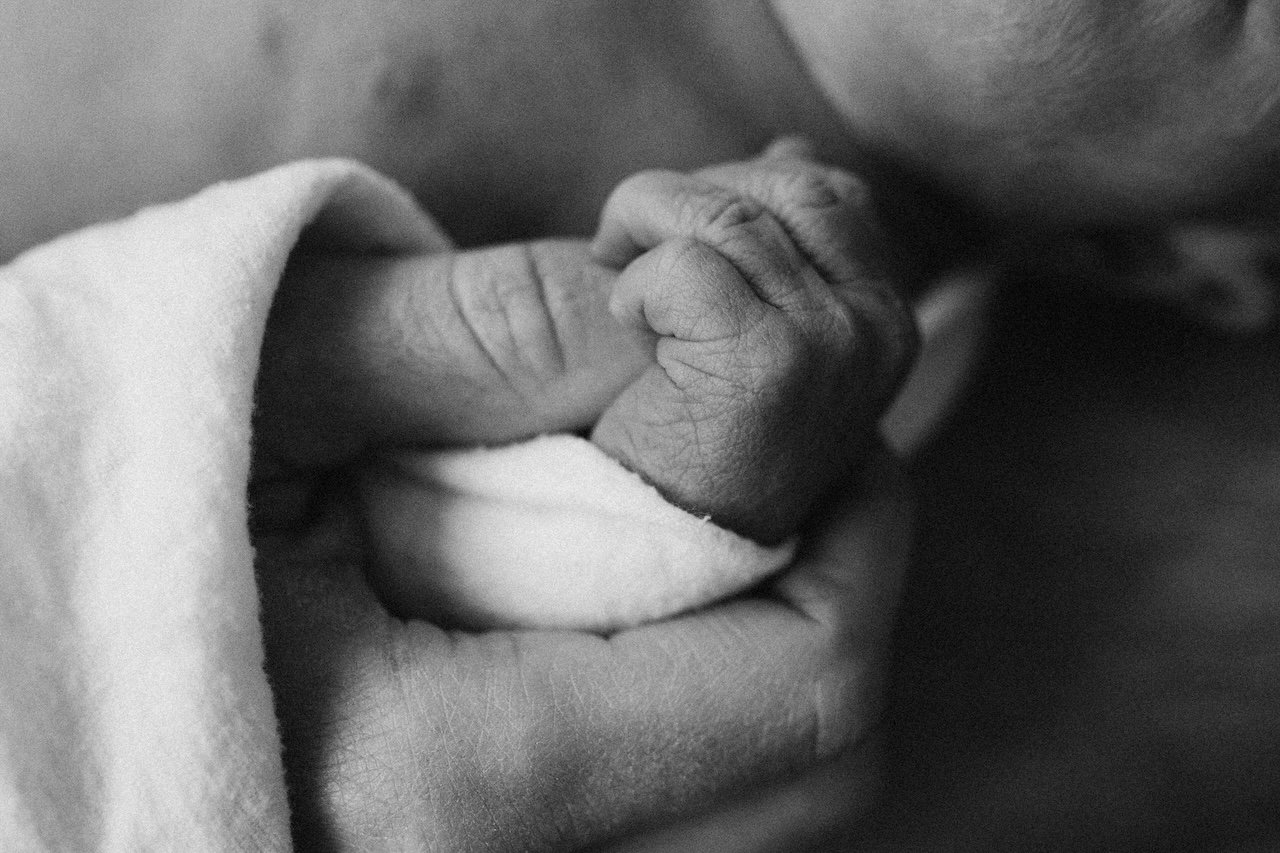 Close-up of a newborn baby's tiny feet and hospital identification bracelet in Cleveland, Ohio