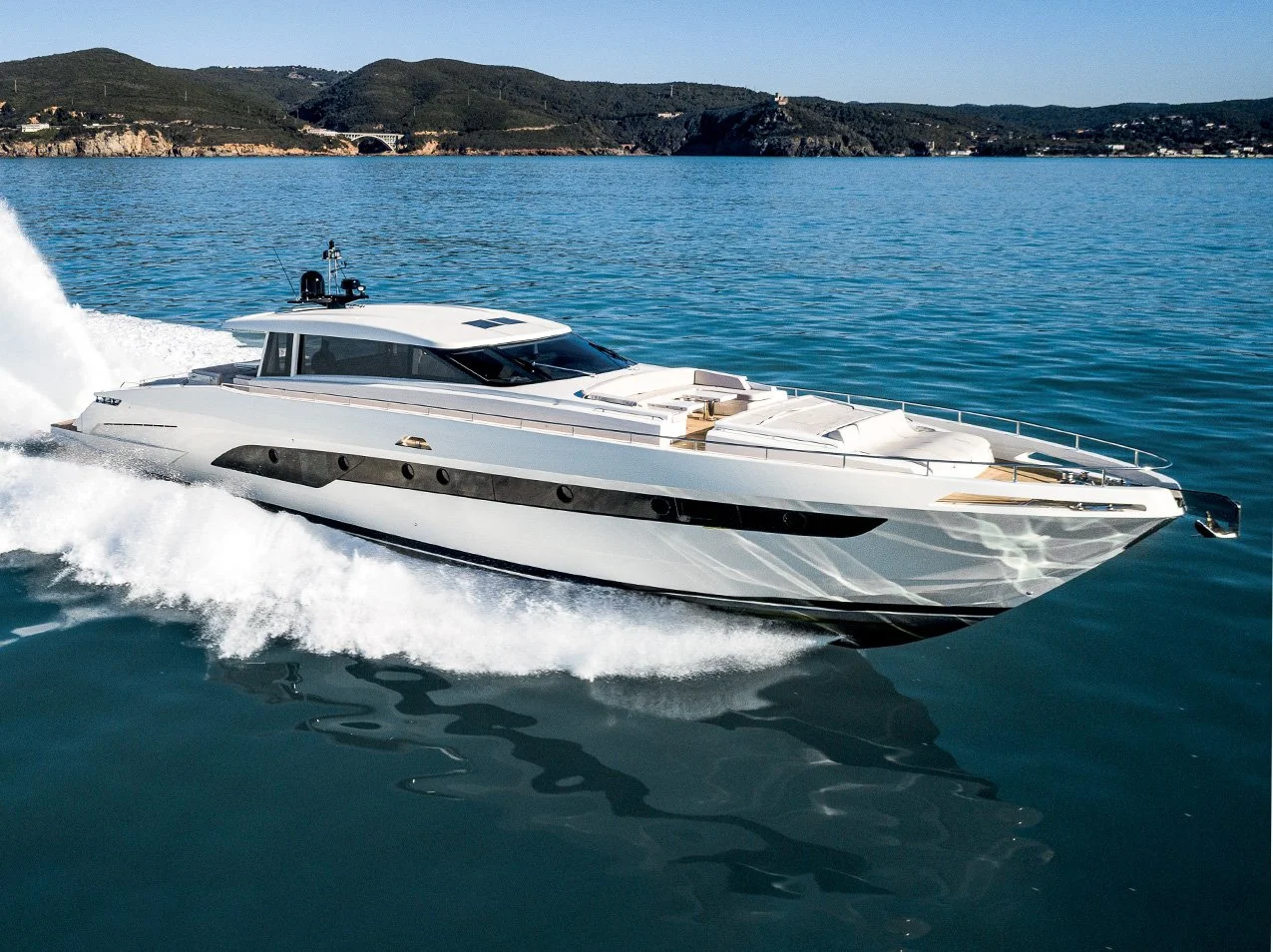 Global Wealth Maritima features a luxury white yacht cruising on calm blue water with distant green hills in the background.