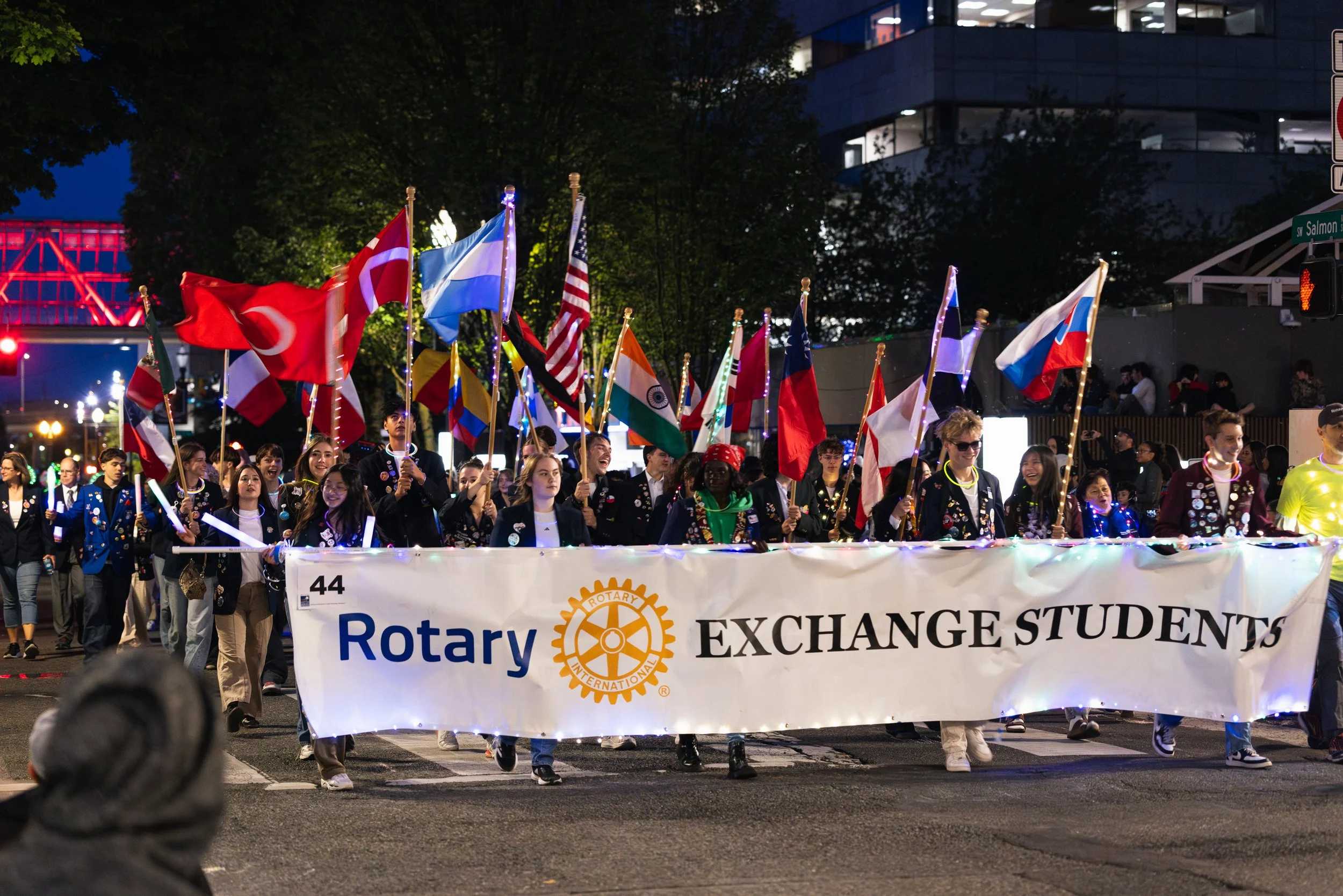 People waving a banner in the Starlight Parade in Portland, OR.