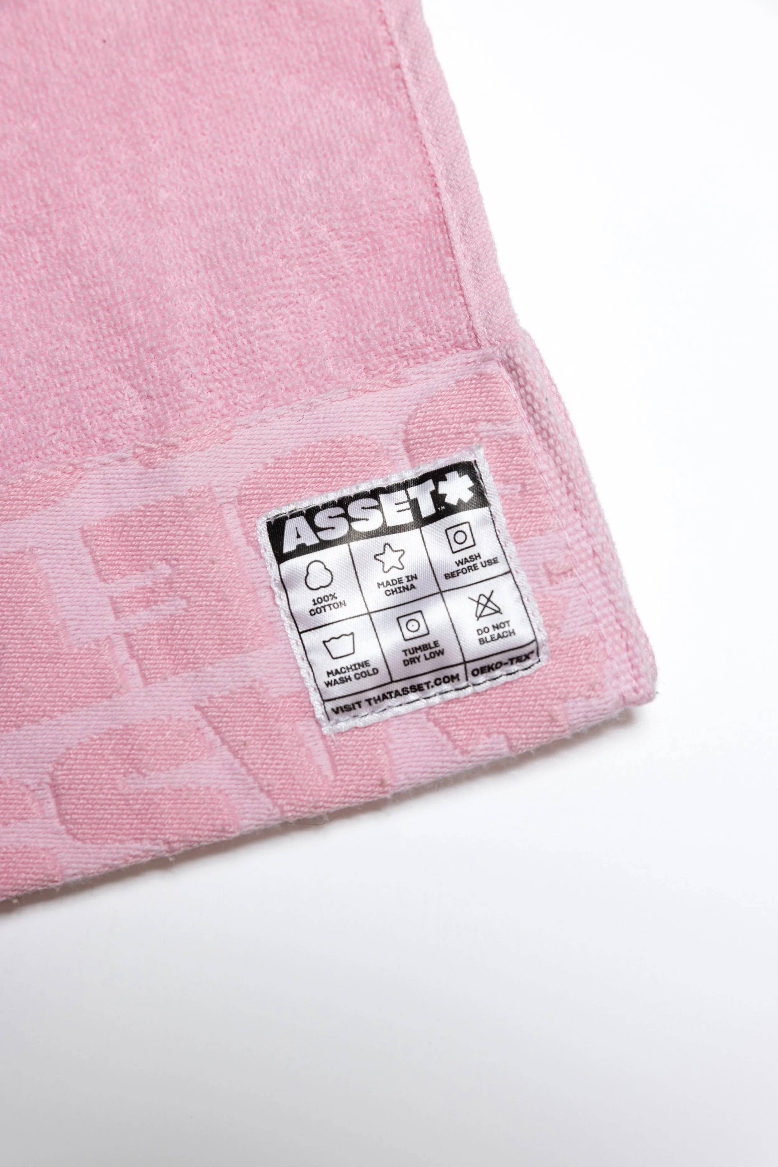 Pink hand towel product photography in a studio by Portland, Oregon product photographer, JP Bogan. PDX Product Photography at SumSum Productions studio.
