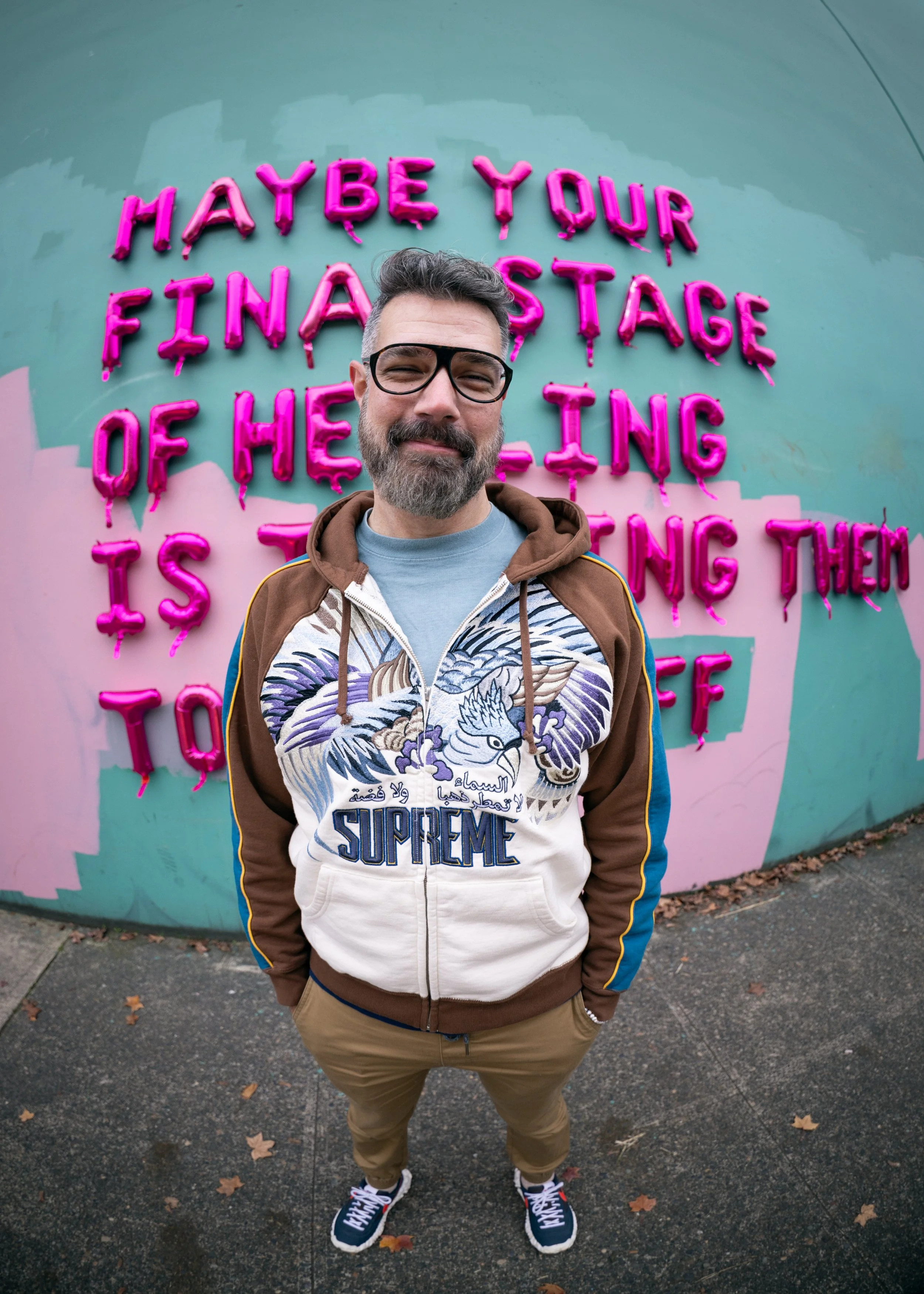 Portrait of BLCKSMTH in front of one of his balloon art installations in Portland, OR.