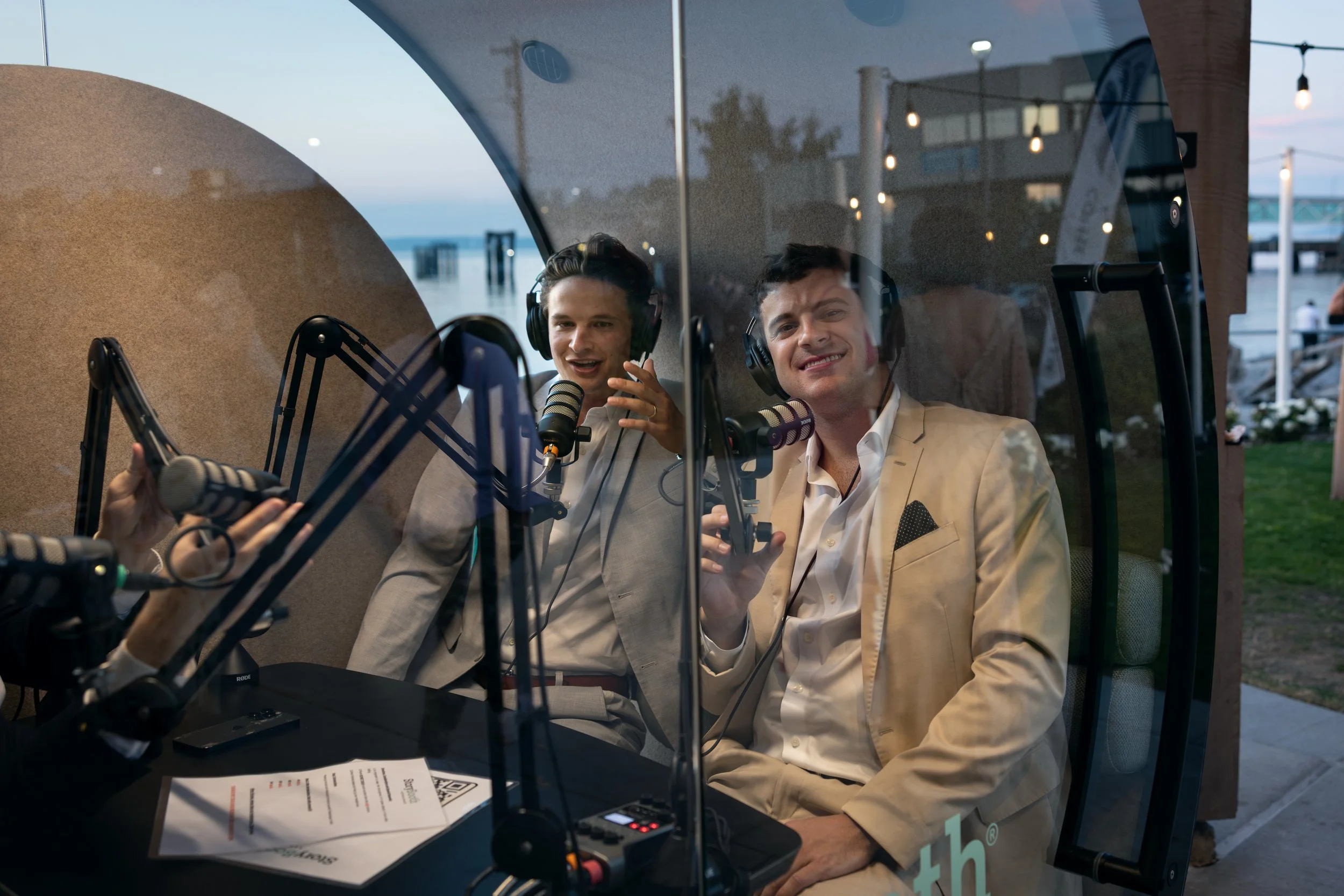 Groomsmen in a podcast booth at a wedding telling stories. Story Booth Experience product photography at a wedding in Seattle.