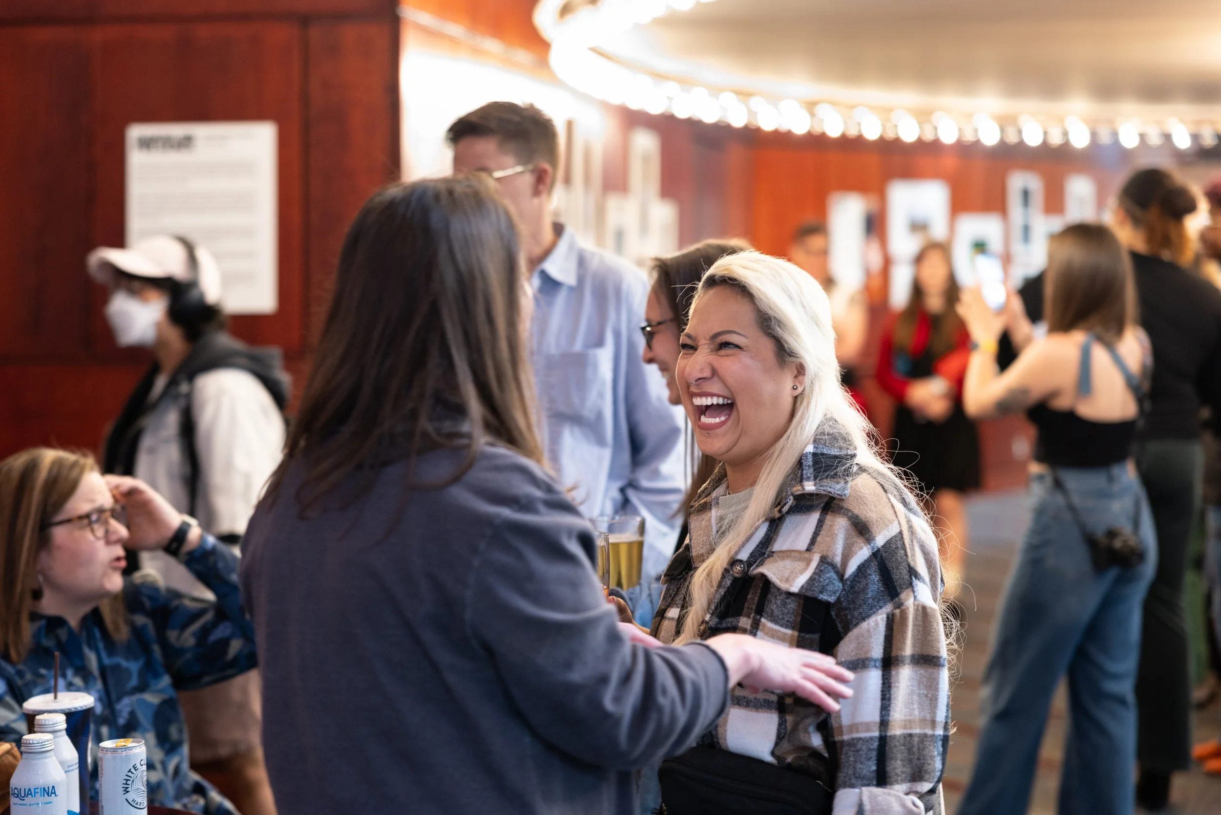 A couple having an exciting conversation at Framing Our Presence event at Portland 5 Winningstad Theater in Portland, Oregon. Event Photography bu JP Bogan.