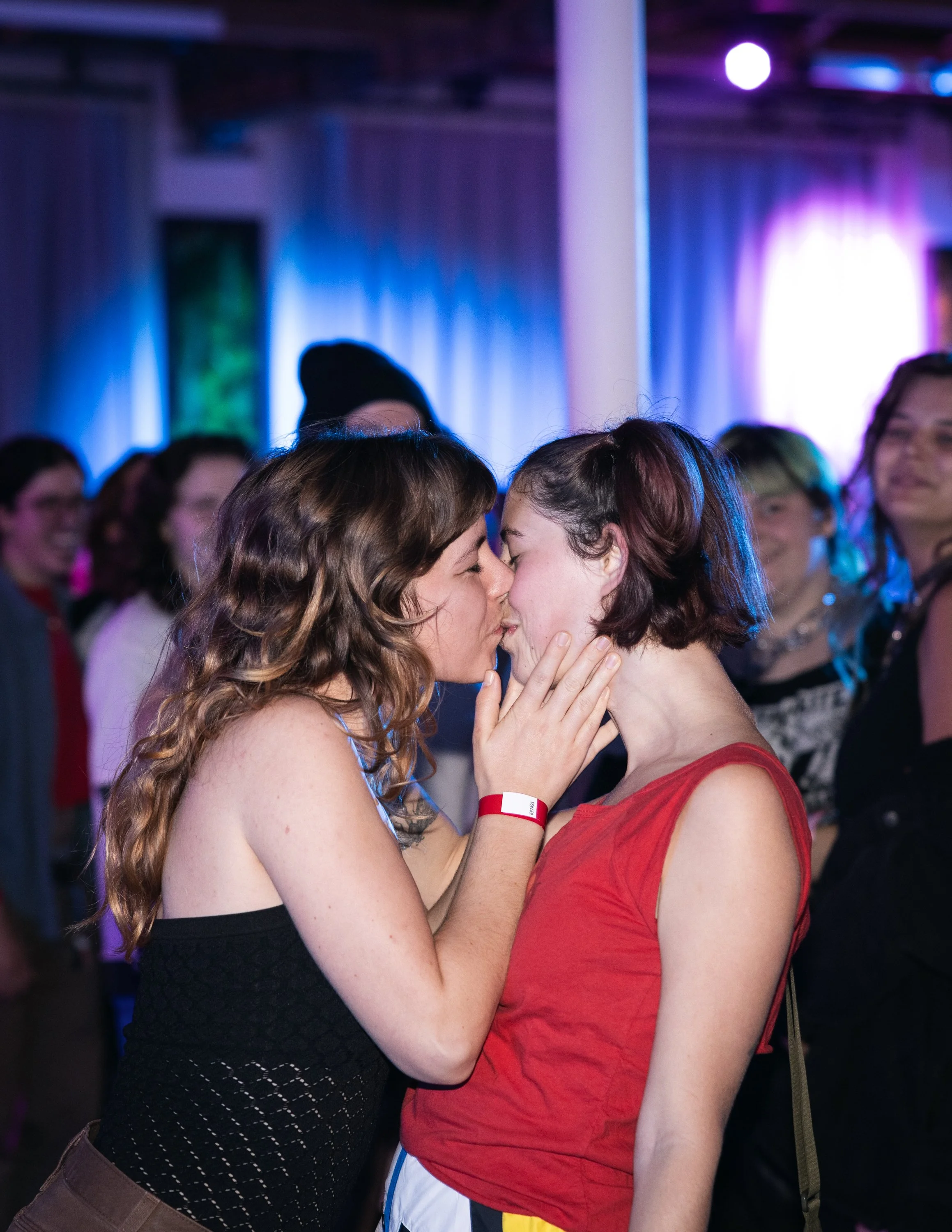 Two people kissing for the kiss cam at TBOY Wrestling in Portland, OR.