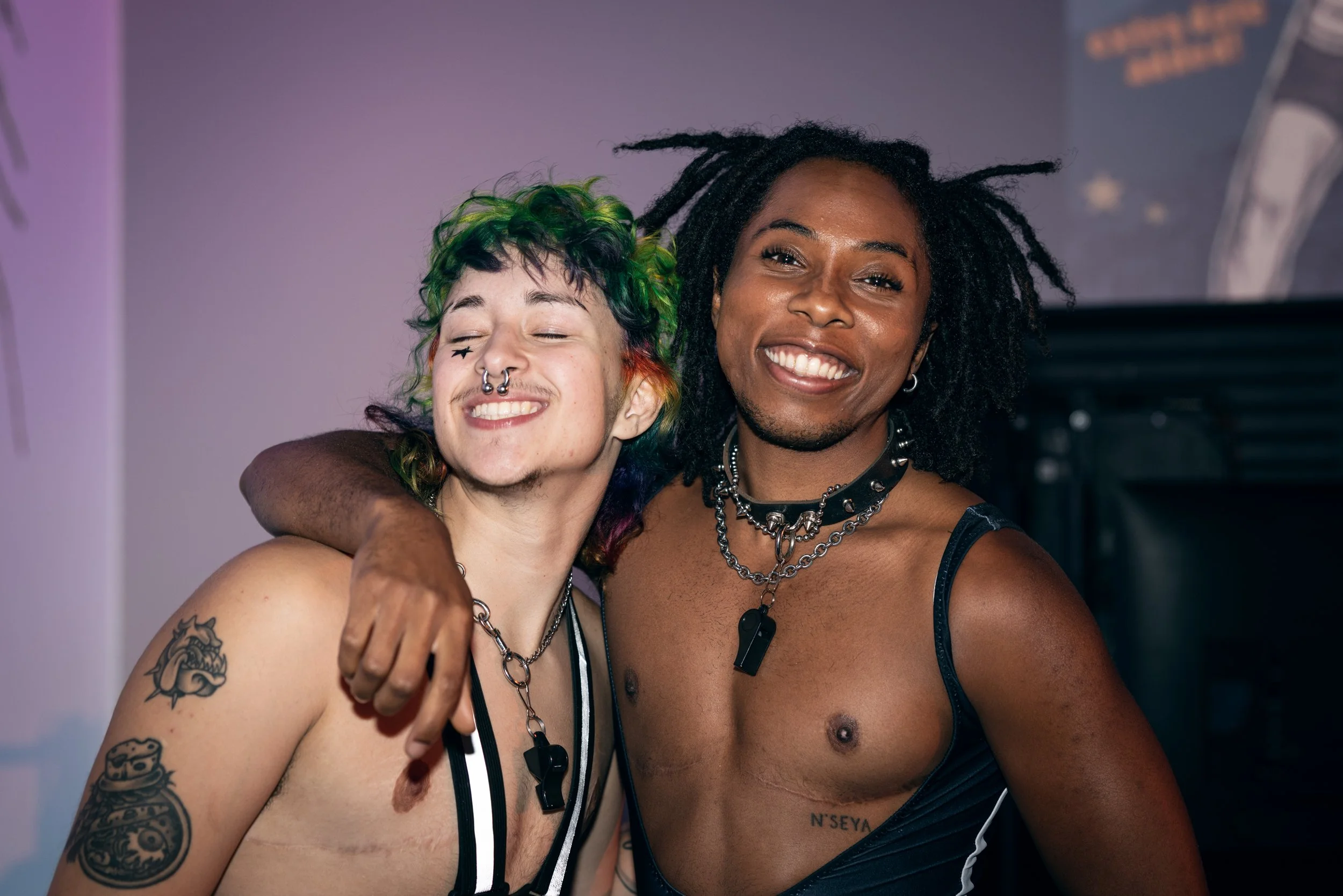 Two referees smile for the camera at TBOY Wrestling in Portland, OR.
