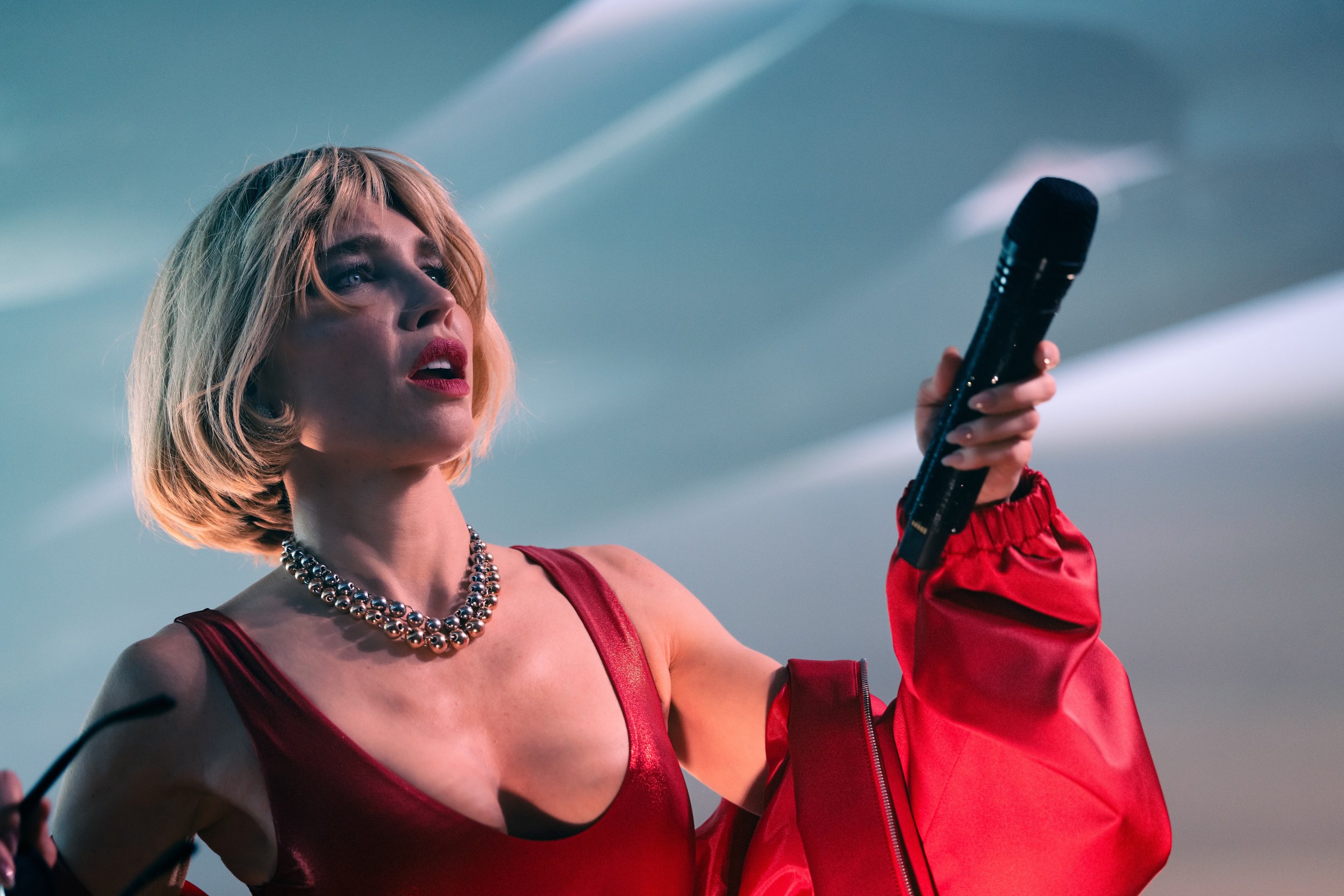 Goldie Boutilier in a red outfit performing at The Get Down music venue in Portland, OR. Concert photography by JP Bogan. 