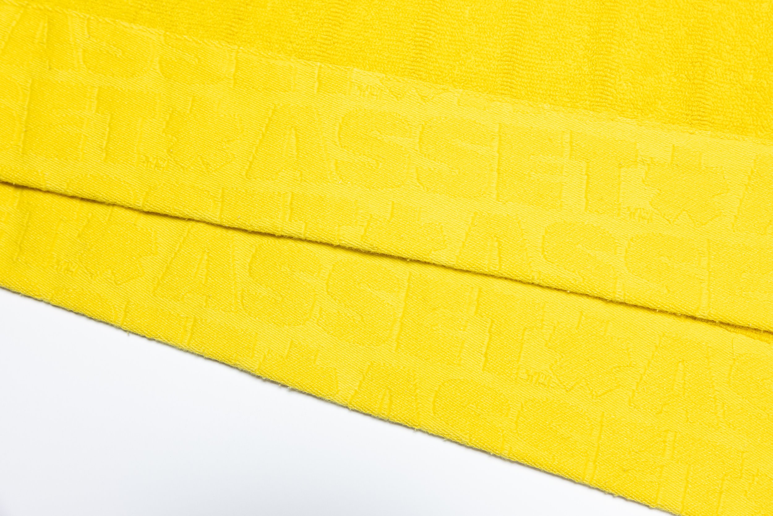 Yellow hand towel product photography in a studio by Portland, Oregon product photographer, JP Bogan. PDX Product Photography at SumSum Productions studio.