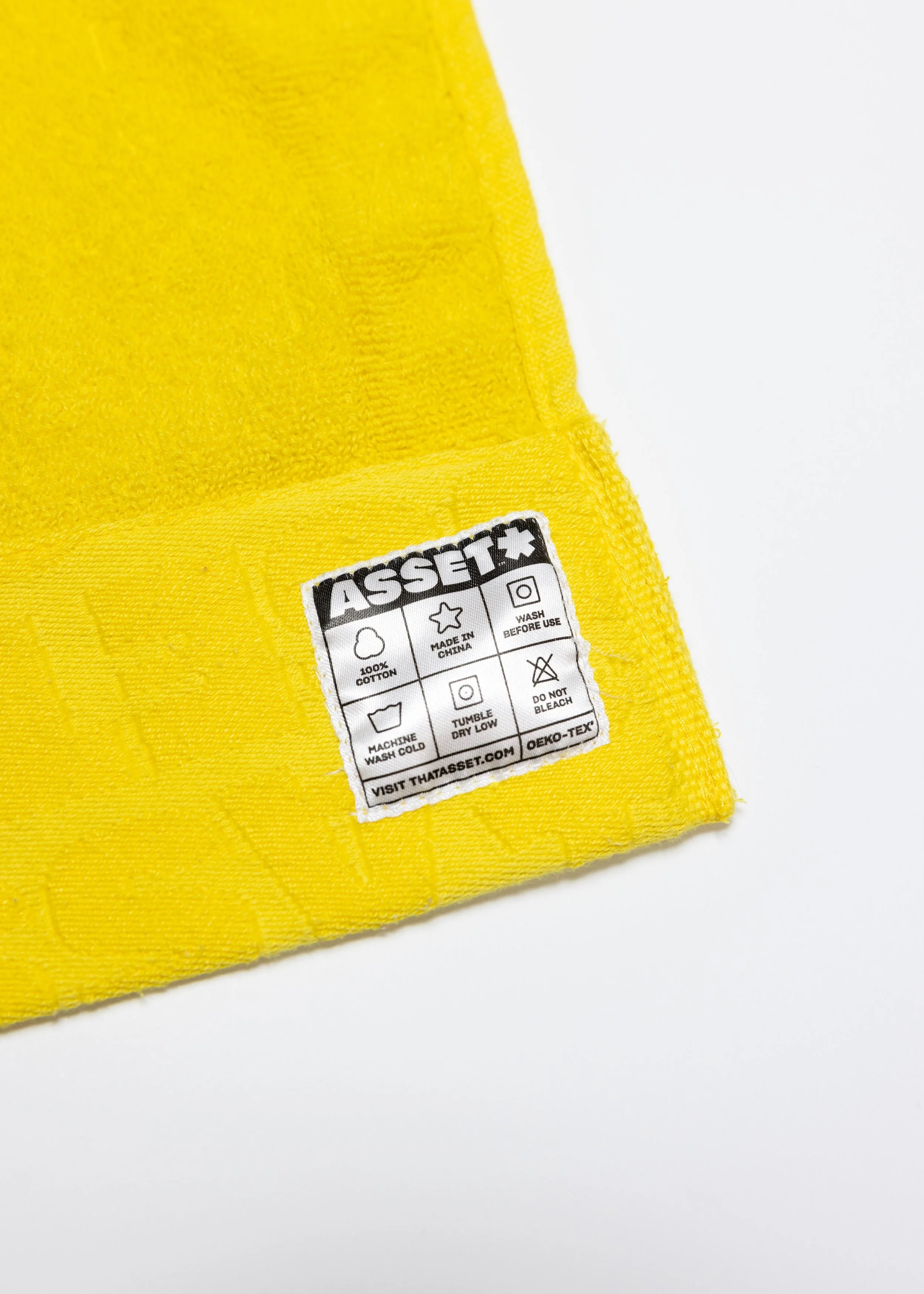 Yellow hand towel product photography in a studio by Portland, Oregon product photographer, JP Bogan. PDX Product Photography at SumSum Productions studio.