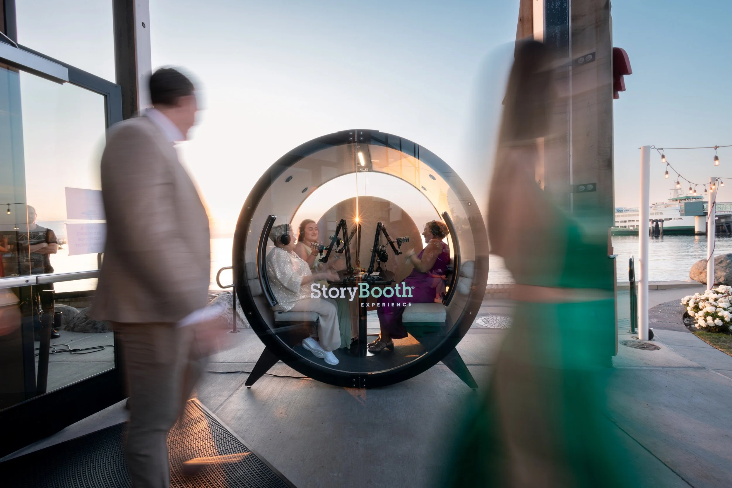 People sitting in a podcast booth at an event telling stories. Story Booth Experience product photography at a wedding in Seattle.