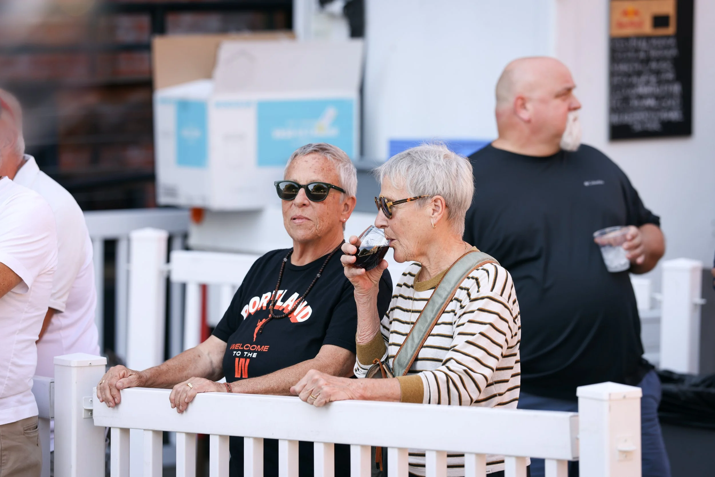 A couple drinking wine at the Pearl Summer Party in downtown Portland, OR.