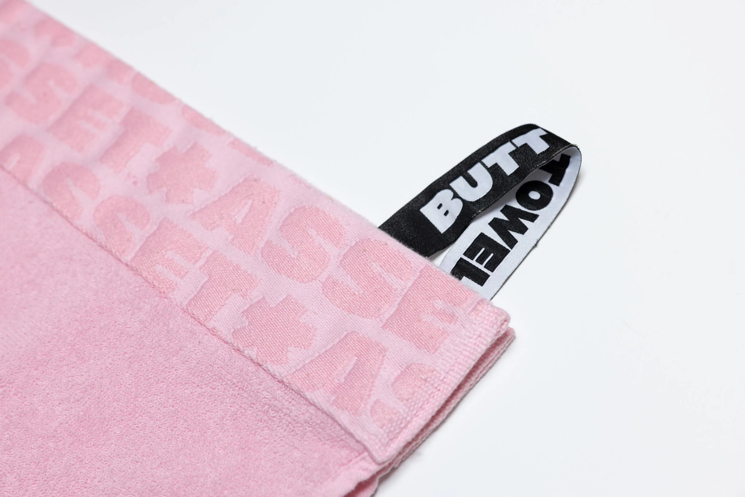 Pink butt towel product photography in a studio by Portland, Oregon product photographer, JP Bogan. PDX Product Photography at SumSum Productions studio.