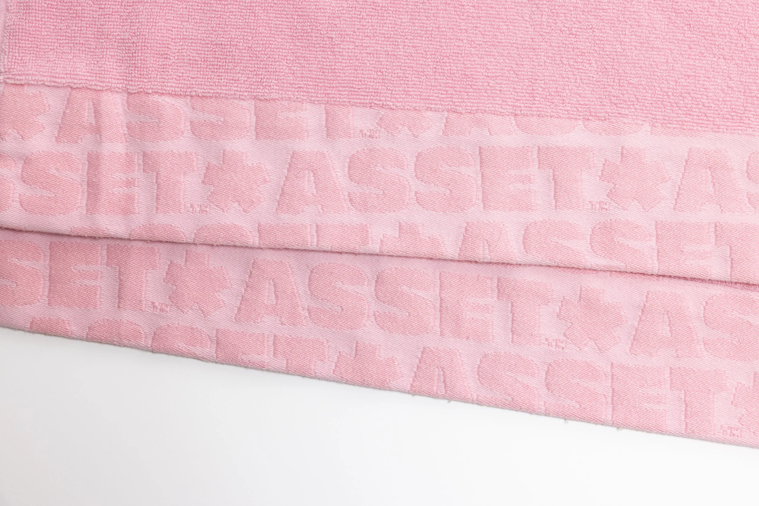 Pink hand towel product photography in a studio by Portland, Oregon product photographer, JP Bogan. PDX Product Photography at SumSum Productions studio.