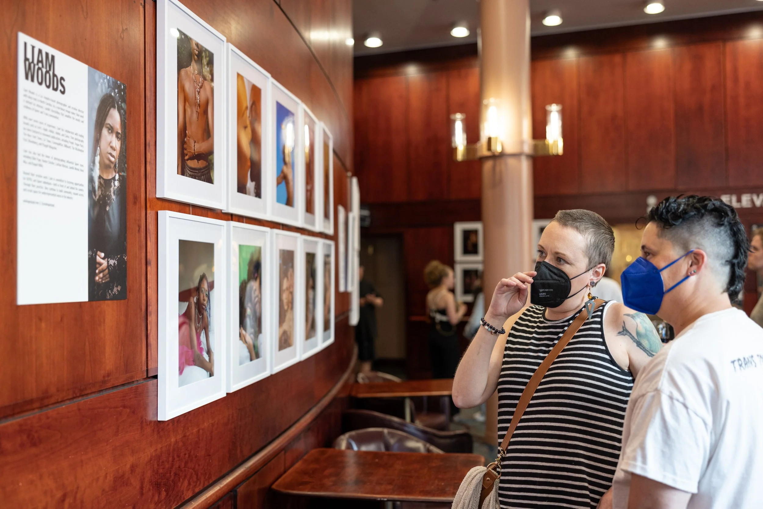 Couple looking at exhibition at Framing Our Presence event at Portland 5 Winningstad Theater in Portland, Oregon. Event Photography bu JP Bogan.