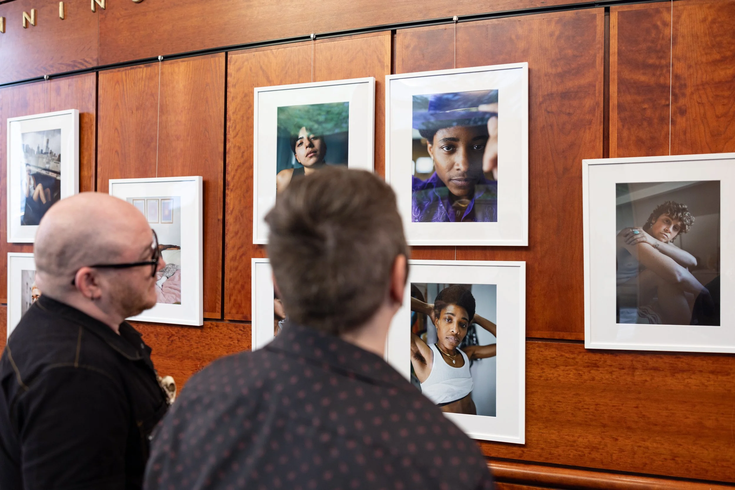 Couple looking at exhibition at Framing Our Presence event at Portland 5 Winningstad Theater in Portland, Oregon. Event Photography bu JP Bogan.