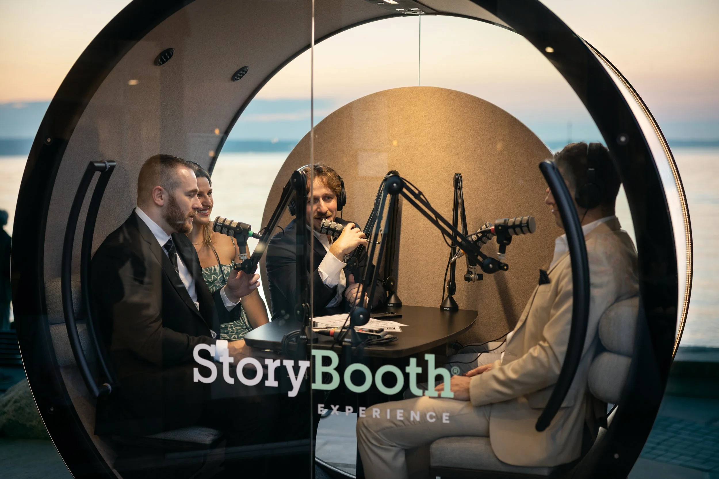 Groomsmen in a podcast booth at a wedding telling stories. Story Booth Experience product photography at a wedding in Seattle.