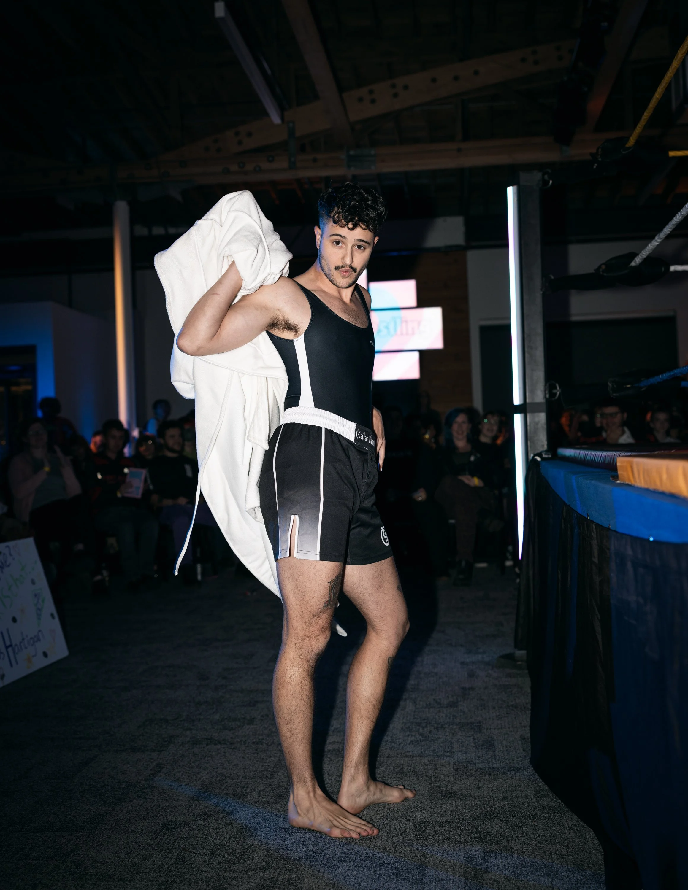 A trans man doing a sexy pose for the camera at TBOY Wrestling in Portland, OR.