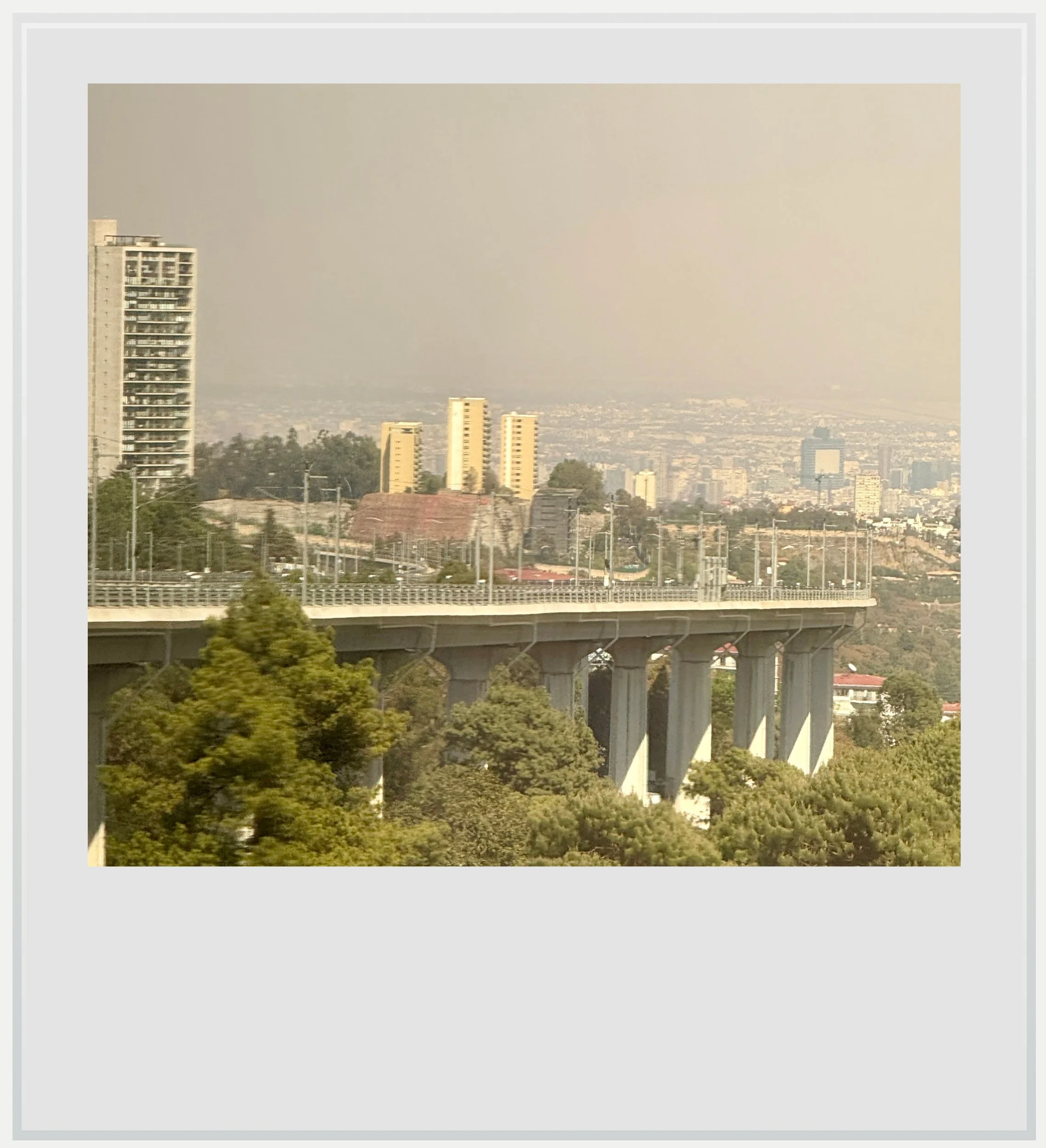 Going down towards Mexico City's center, in the fog of a sunny day in February.