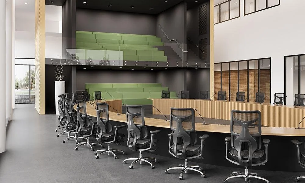 Large modern conference room with tiered seating and a circular table surrounded by office chairs