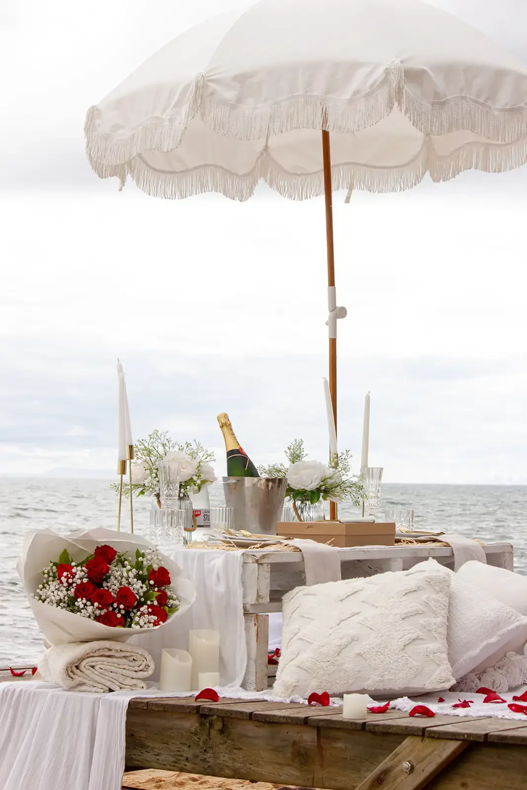 rose petals around pop up picnic for proposal