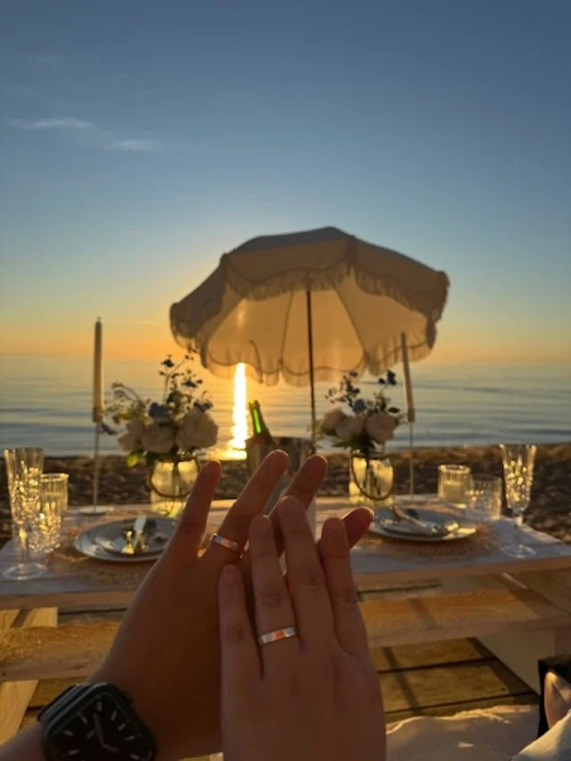 Sunset proposal on the beach in a beach box.