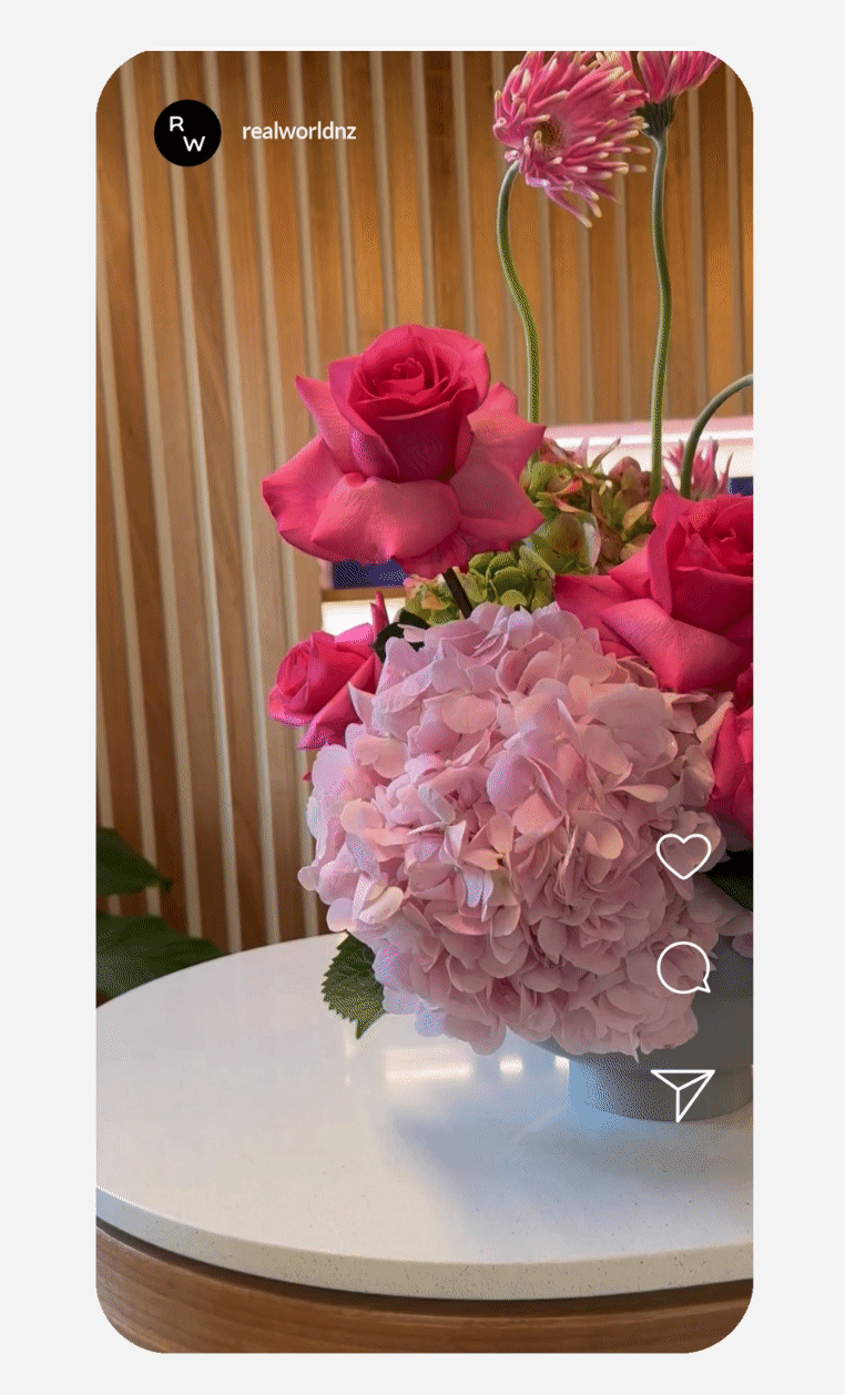 Pink and red floral arrangement in a vase on a table