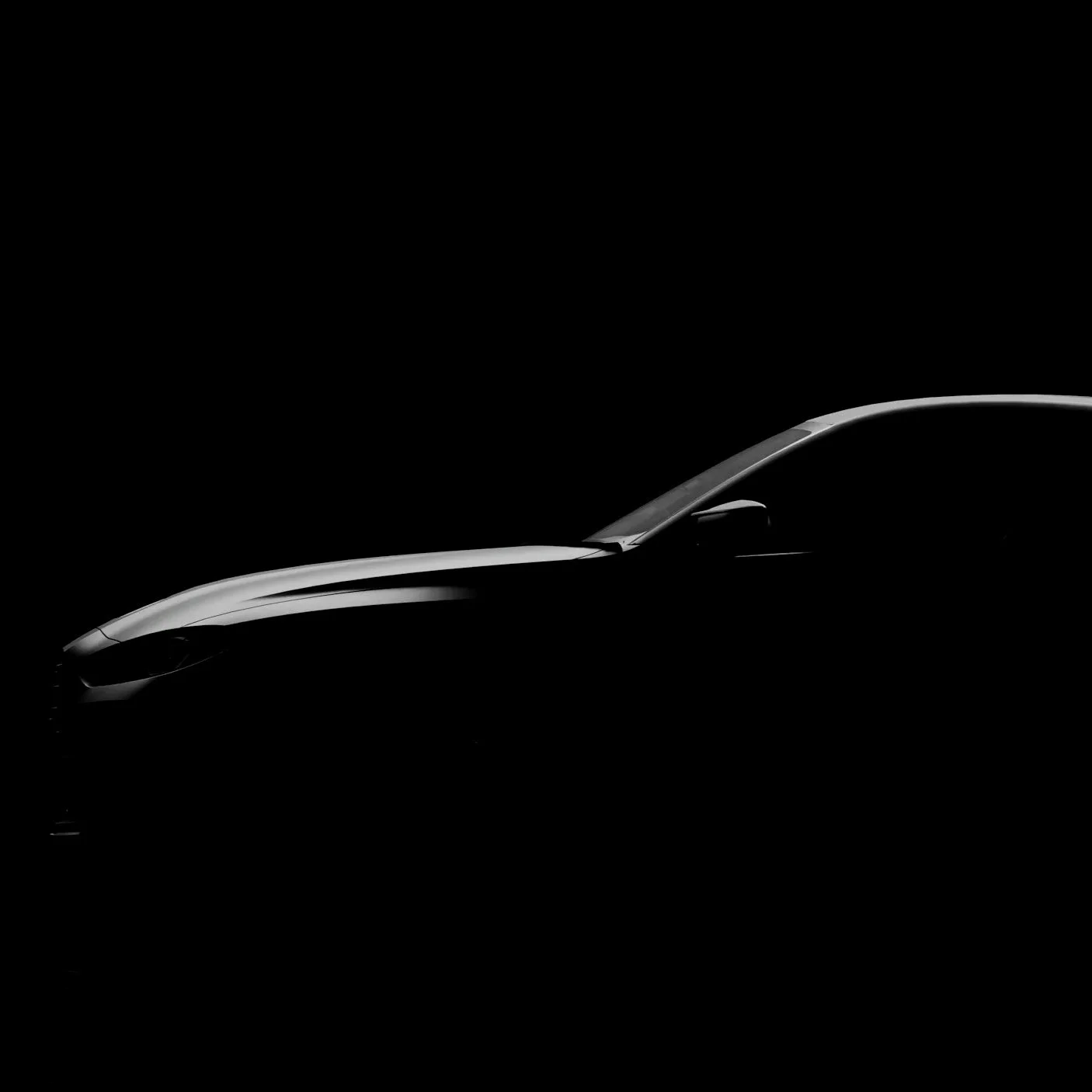 Side view of a sleek, modern car with a faint silhouette visible against a dark background.