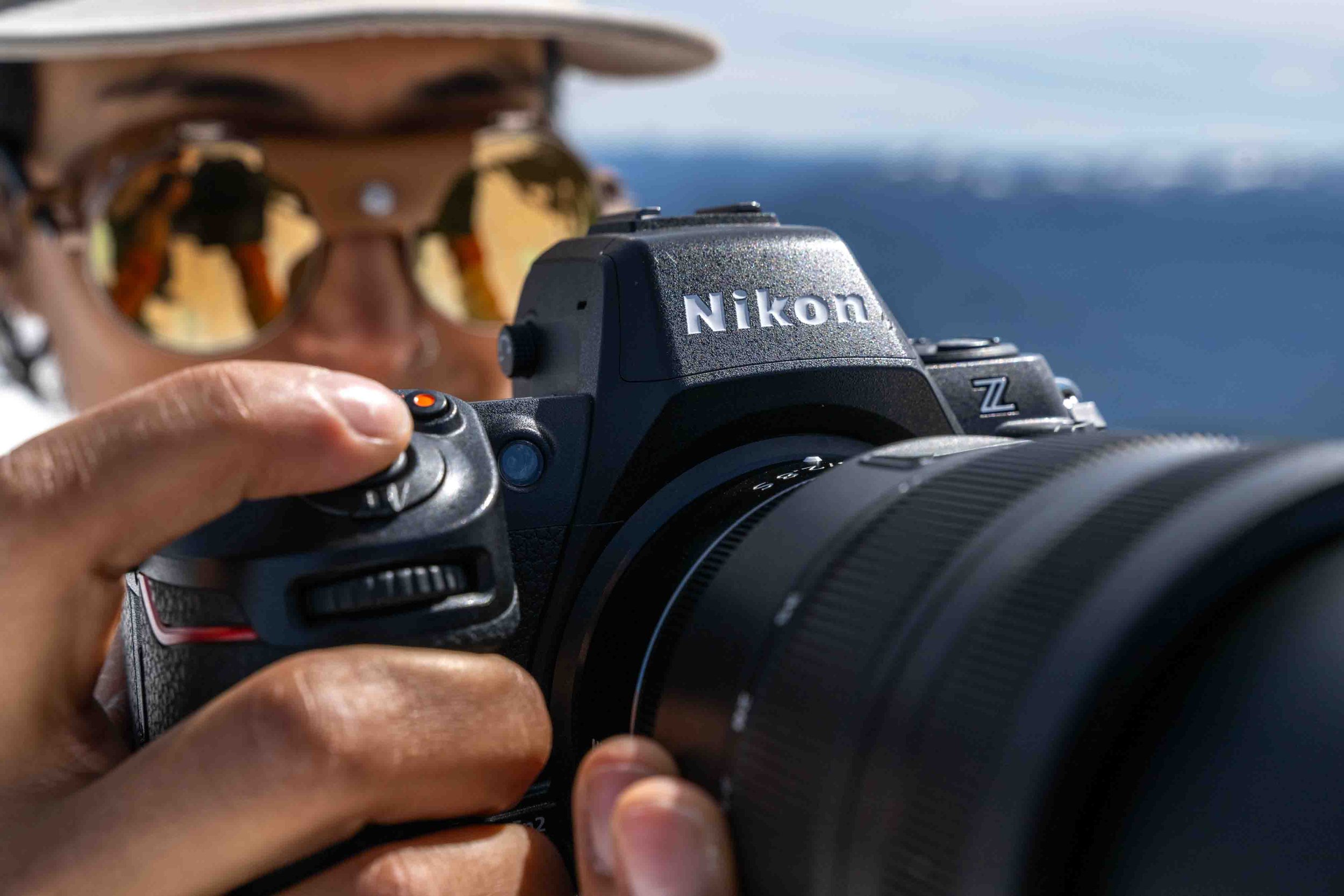 Divya Gordon poised atop a ridge to shoot with the Nikon Z8, the camera model chosen to shoot Maven film. Photographer: Aaron Dickfos