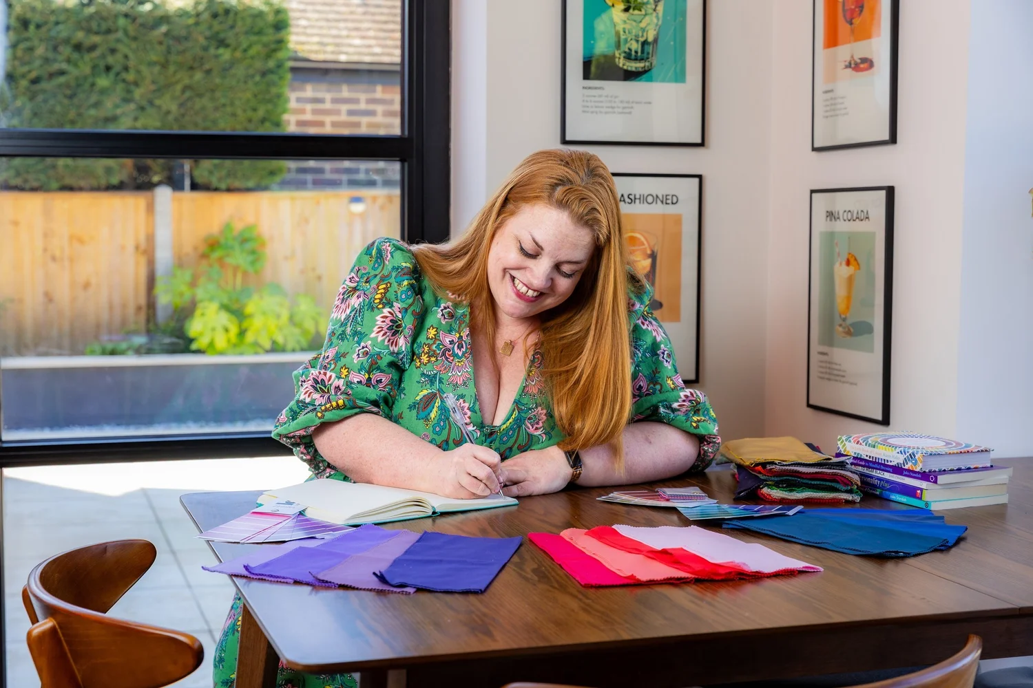 Jodie, surface pattern designer and founder of Colour Rebel Studio, working at her desk surrounded by colour