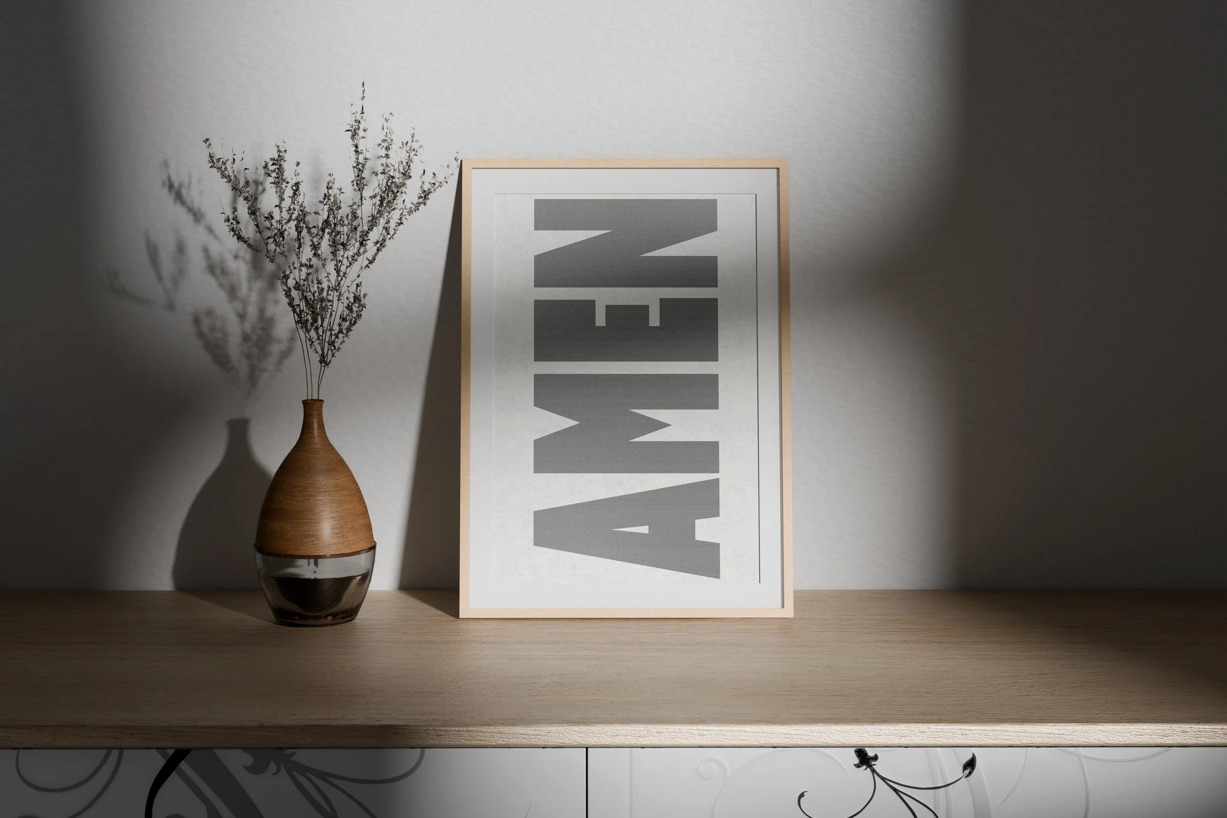 A wooden table with a vase of dried lavender and a framed print with large gray letters spelling 'WAVE'.