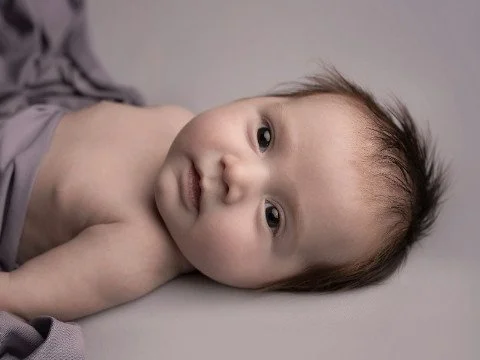 baby-girl-awake-in-bed-with-purple-blanket-480.jpg