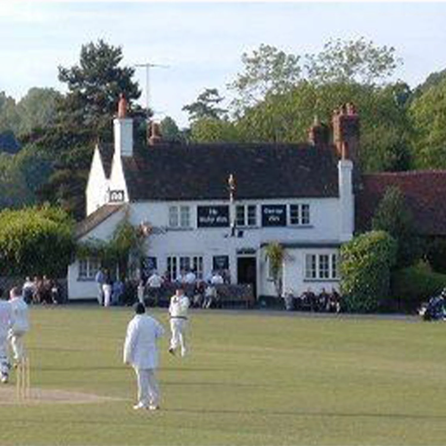 Tilford Cricket on the Village Green with the Barley Mow pub