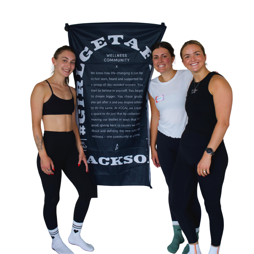 Marge, Christine, and Jordan, the Girl Get After It Jackson Community Leads, with the Jackson banner