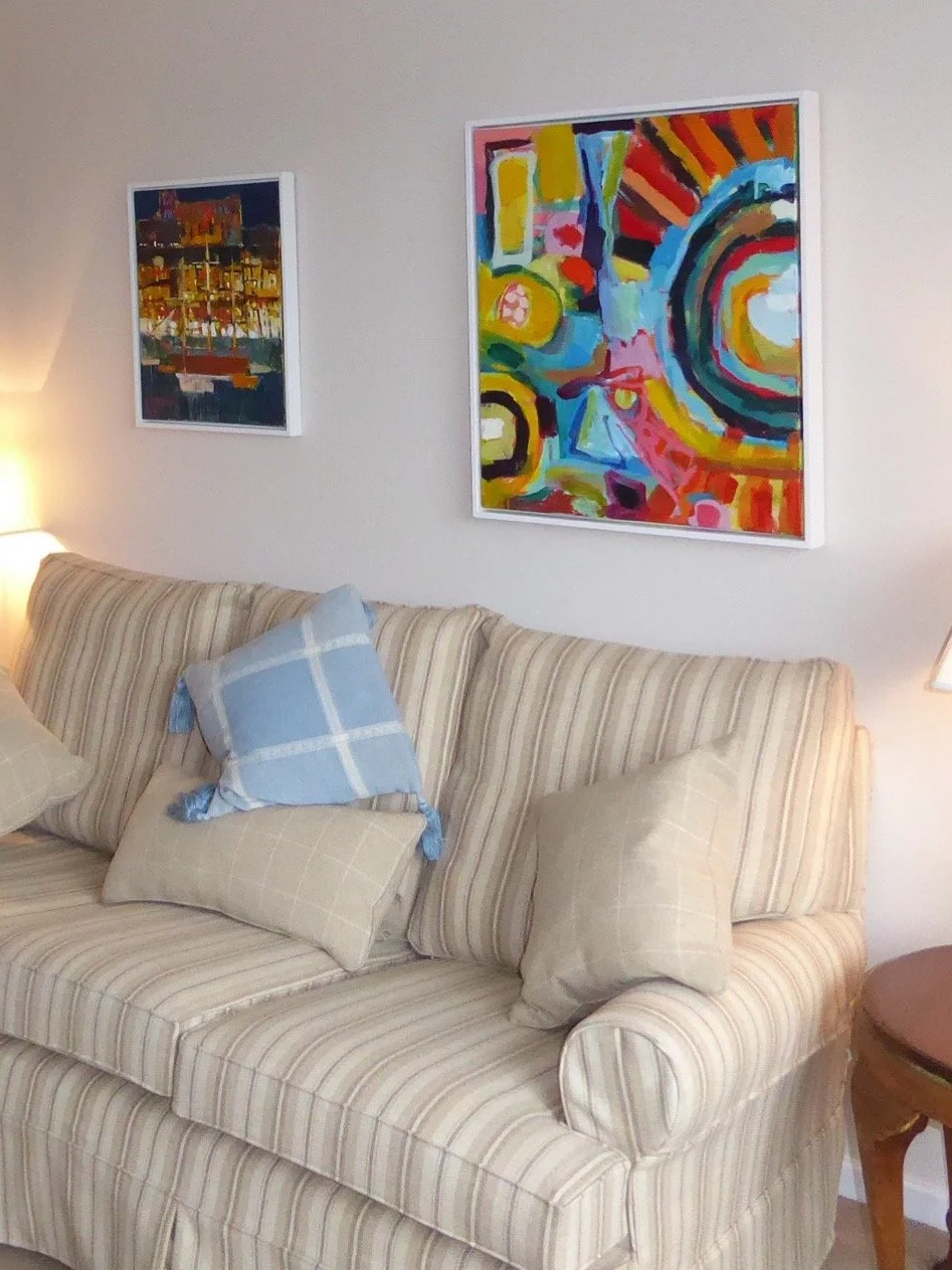 Colourful abstract painting by Liz Foster hanging in a clients home above their sofa
