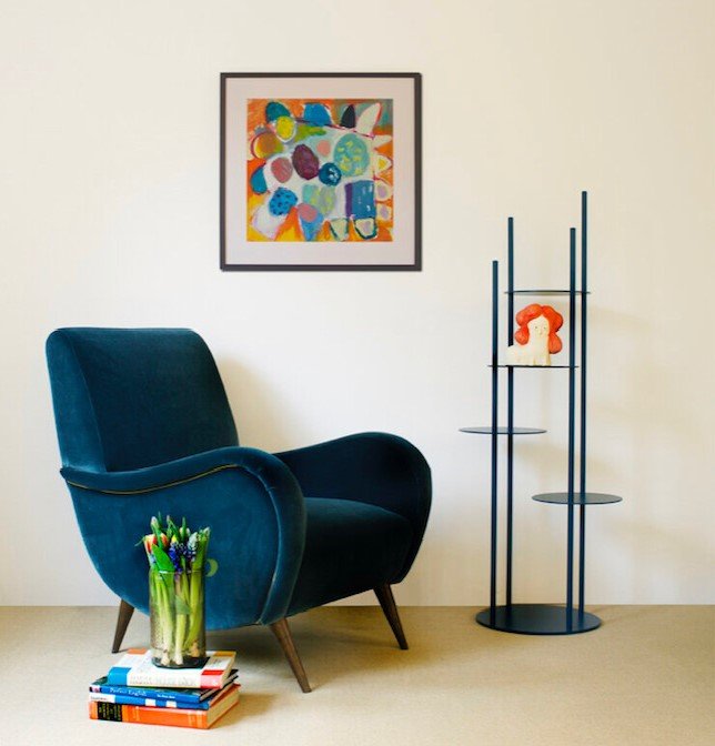 Framed painting called Bloom by Liz Foster hanging in a room setting 