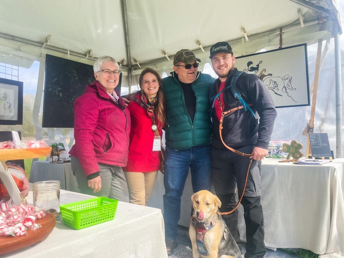 Larissa with her parents at her vendor spaces during the Carolina International