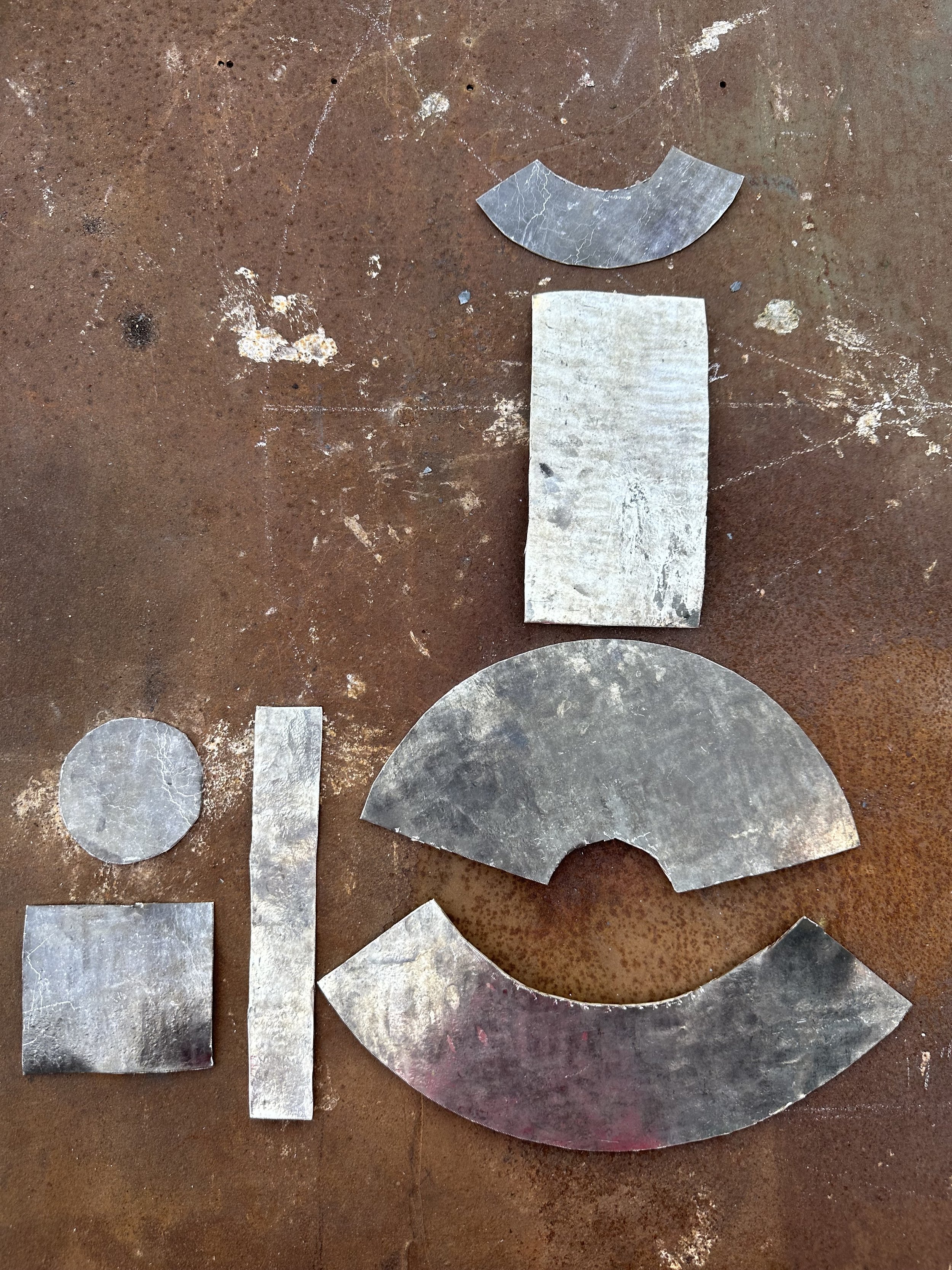 Shapes cut out of pewter sheets