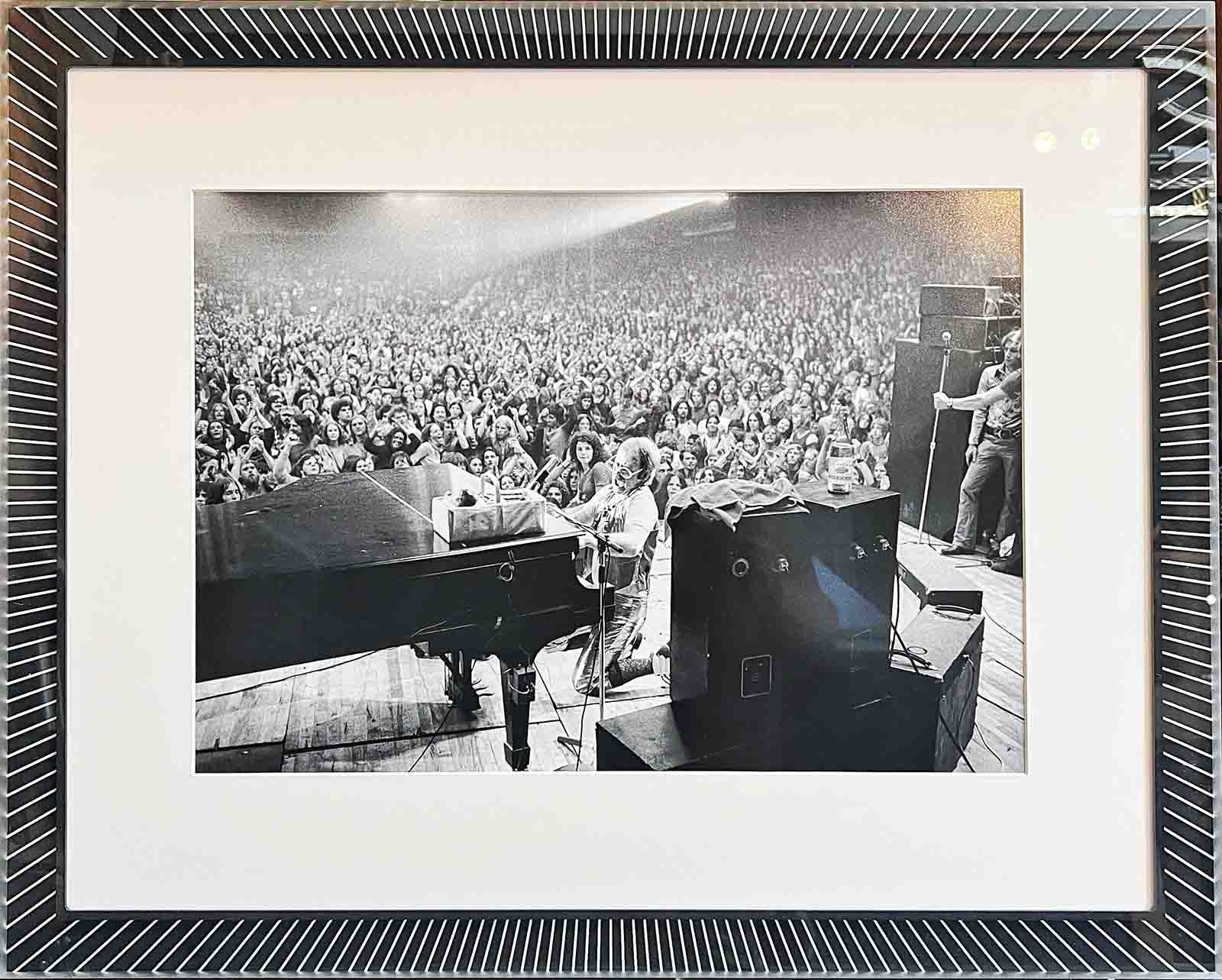 Elton John photo, mounted with cotton rag matting in custom monotone sun ray patterned acrylic frame.