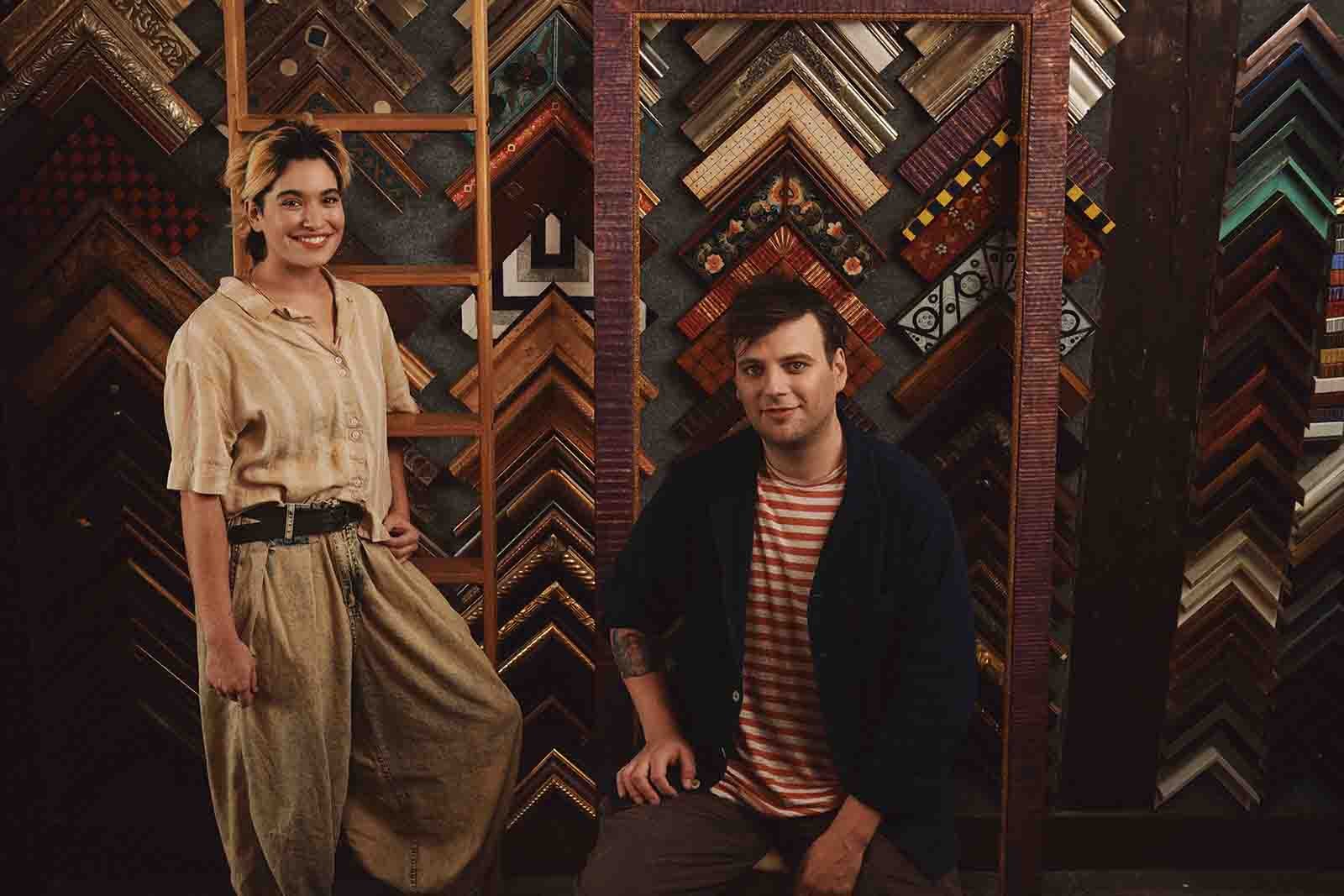 Robert Jones & Bexx Chin, photographed in front of an array of hand carved picture frame samples, at Mangoe Arts & Framing, located in Houston Station, Nashville, TN.