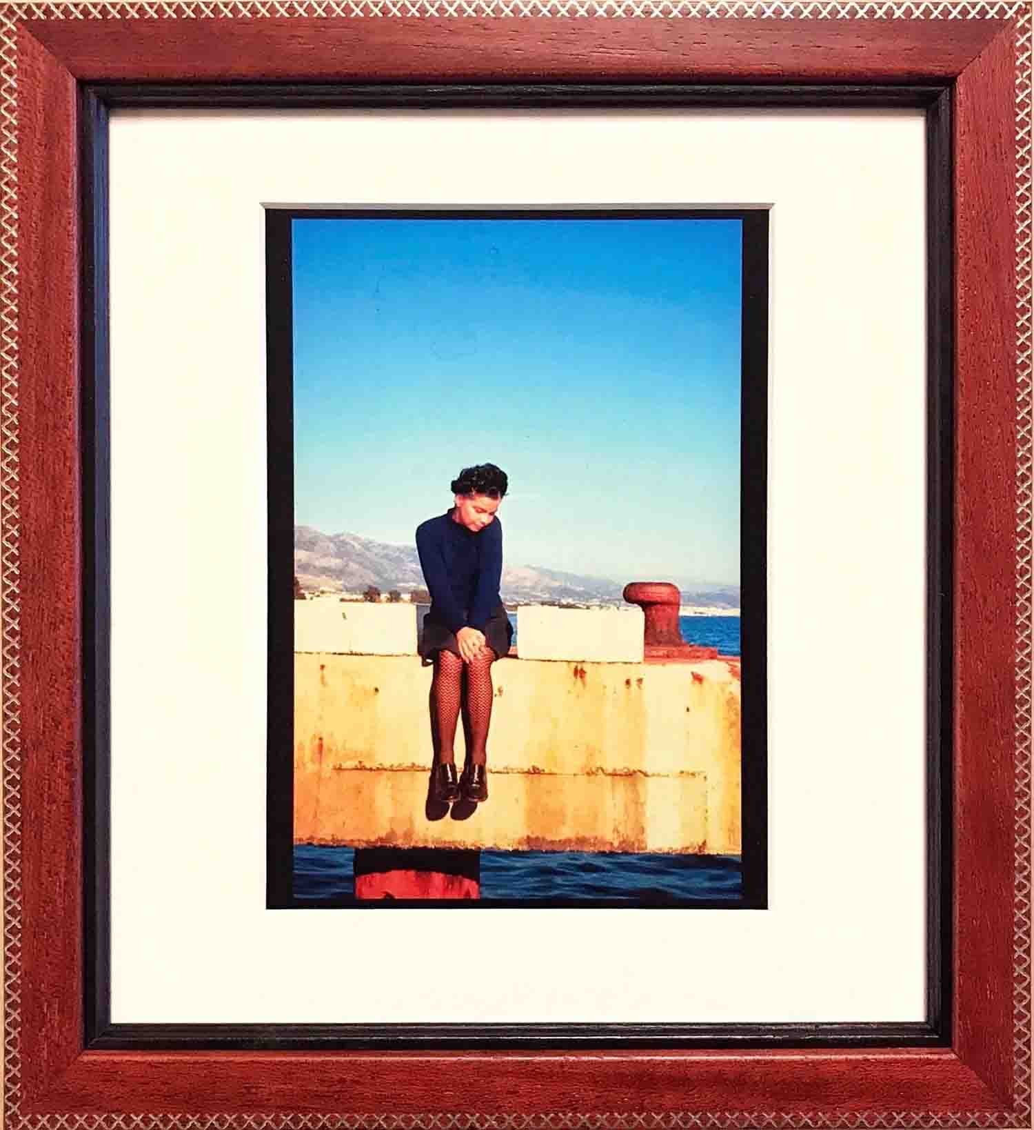 Photograph mounted with cotton rag matting, in hand finished red frame with cross stitch embellishments, with black lacquered fillet.