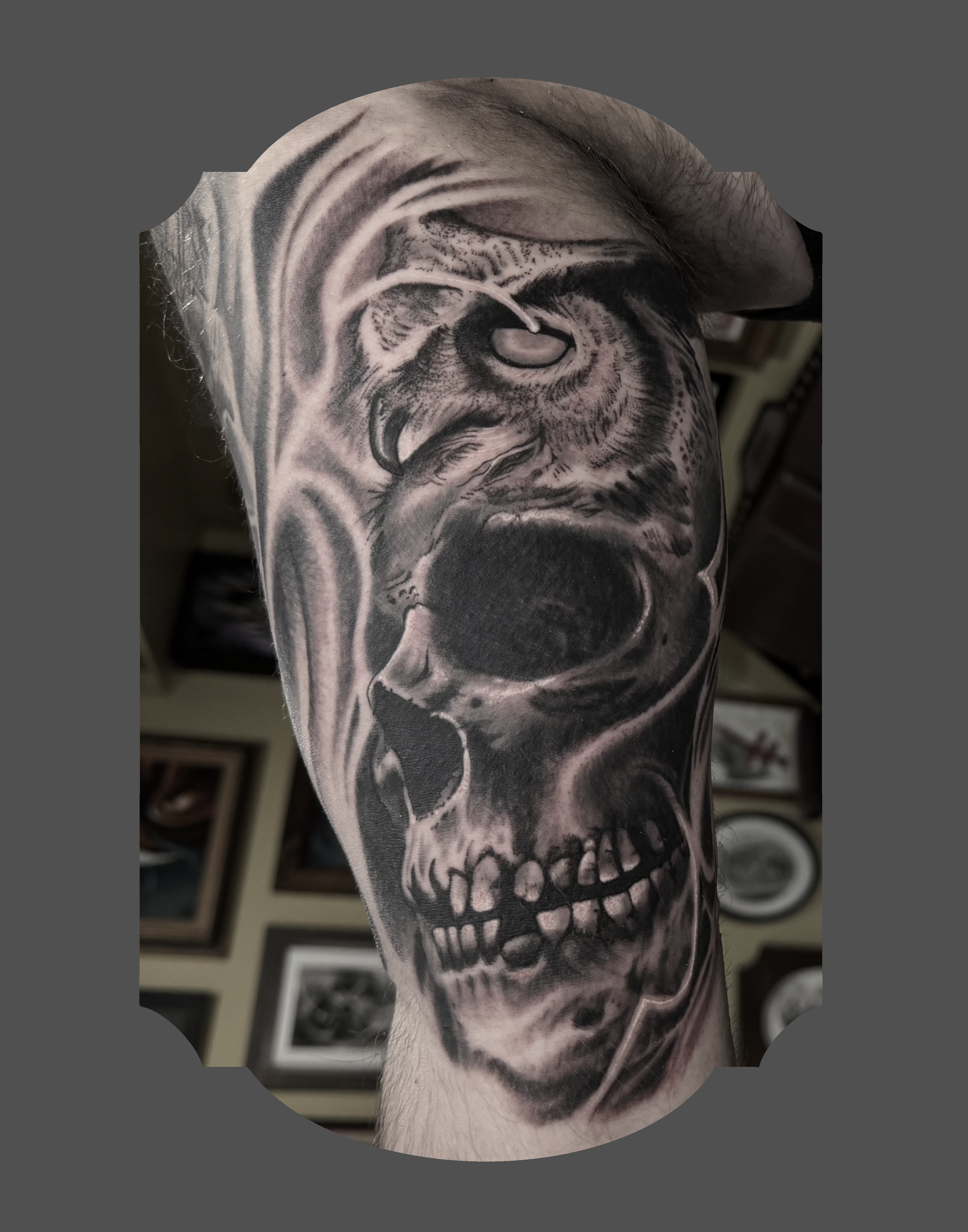 Black and gray tattoo of a human skull on a person's arm, with detailed shading and realistic features.