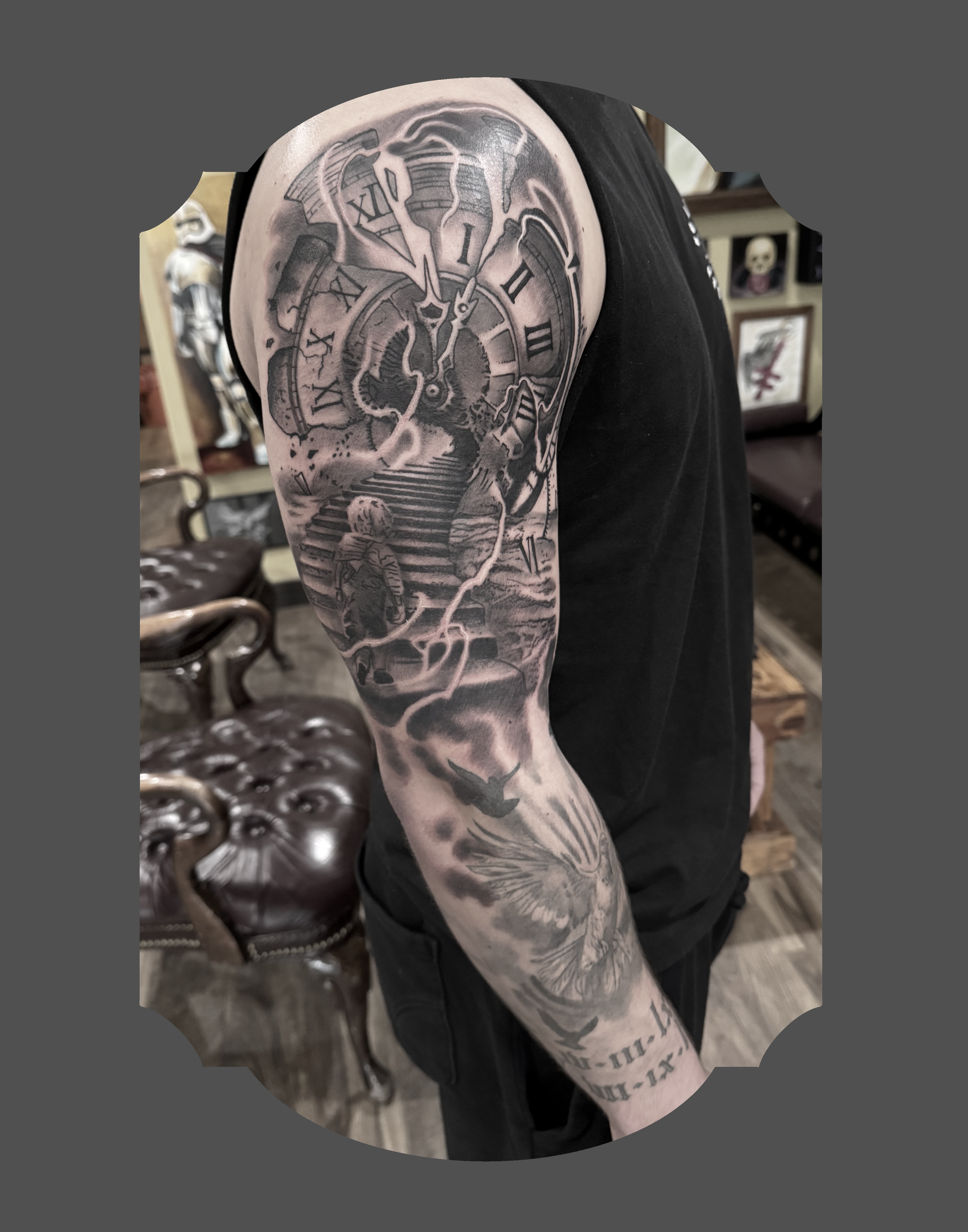 Black and grey tattoo of a vintage clock on a person's upper arm, featuring Roman numerals, a cracked face, and lightning bolts.