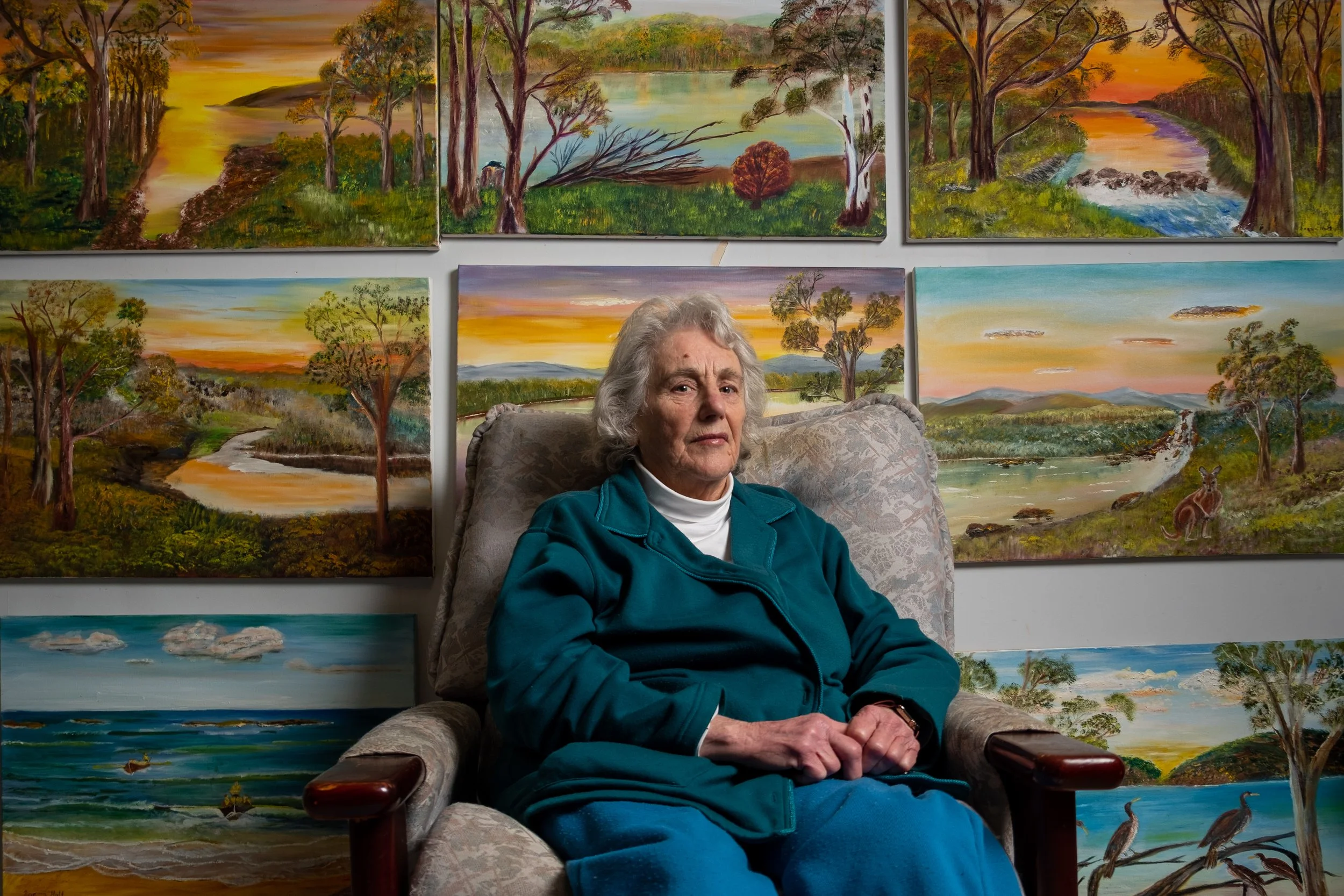 Norma in front of some of her paintings. Canberra, ACT.