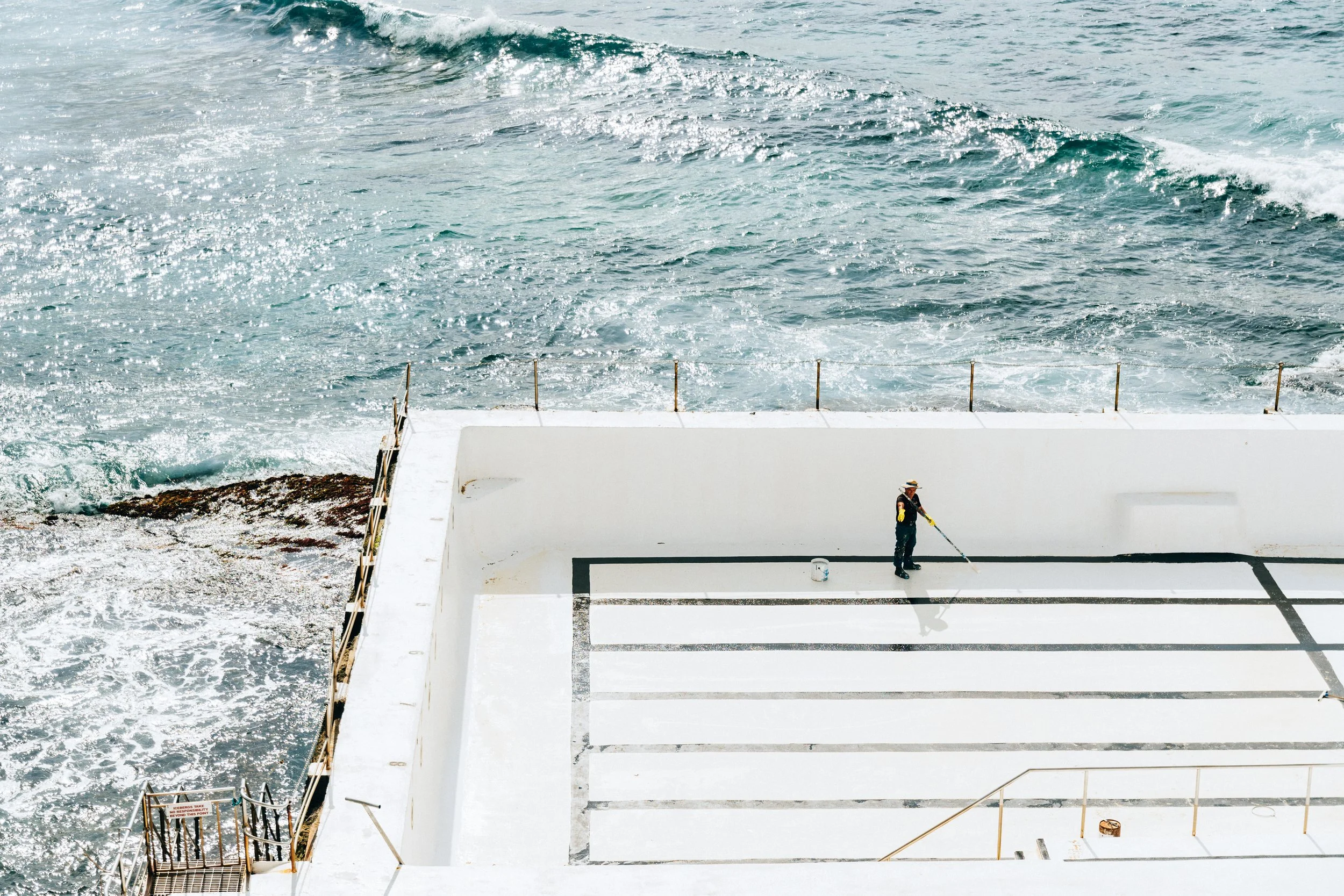 Man repainting Bondi Pool. Sydney, NSW.