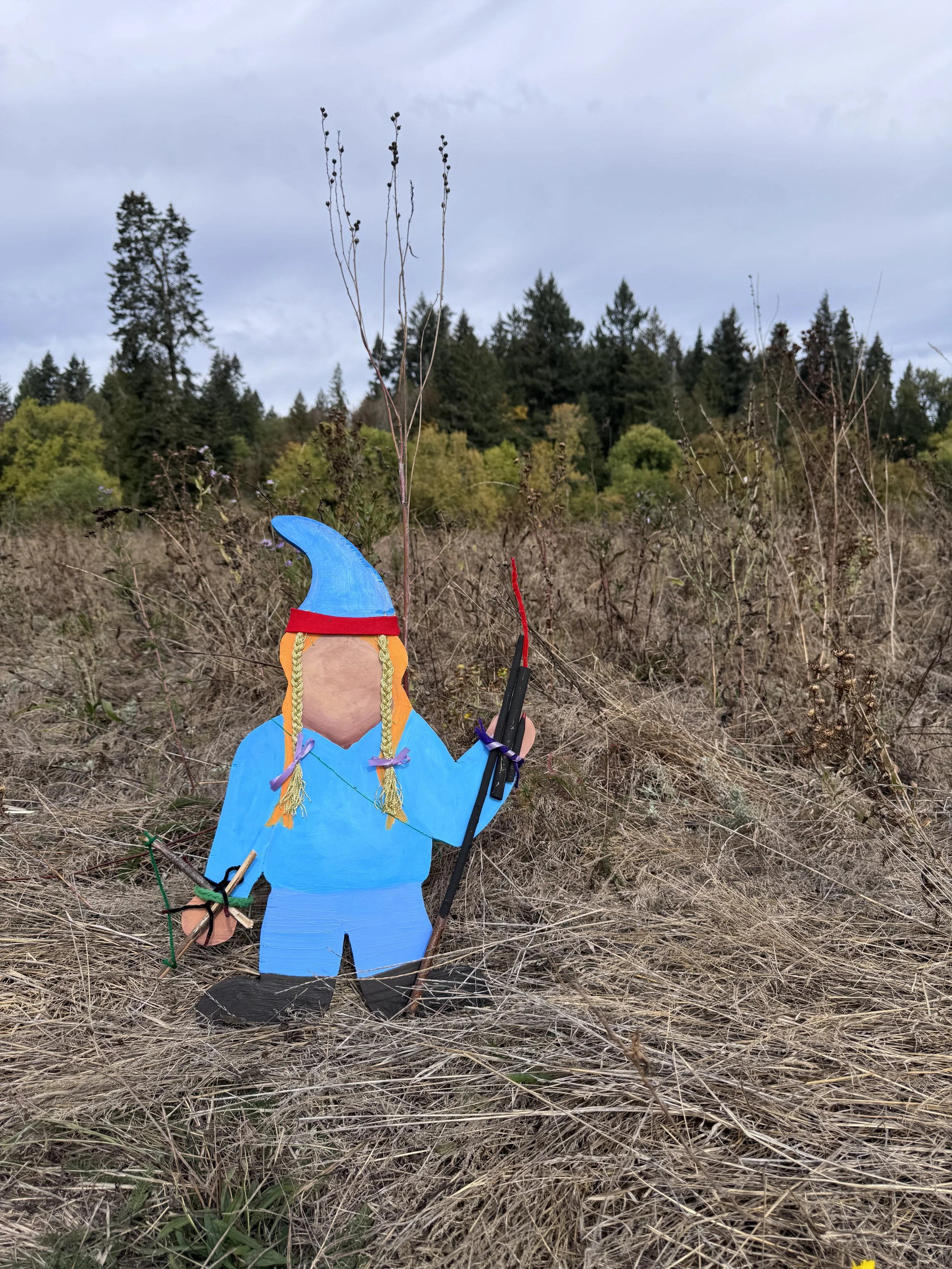 Wooden Gnome in field at farm